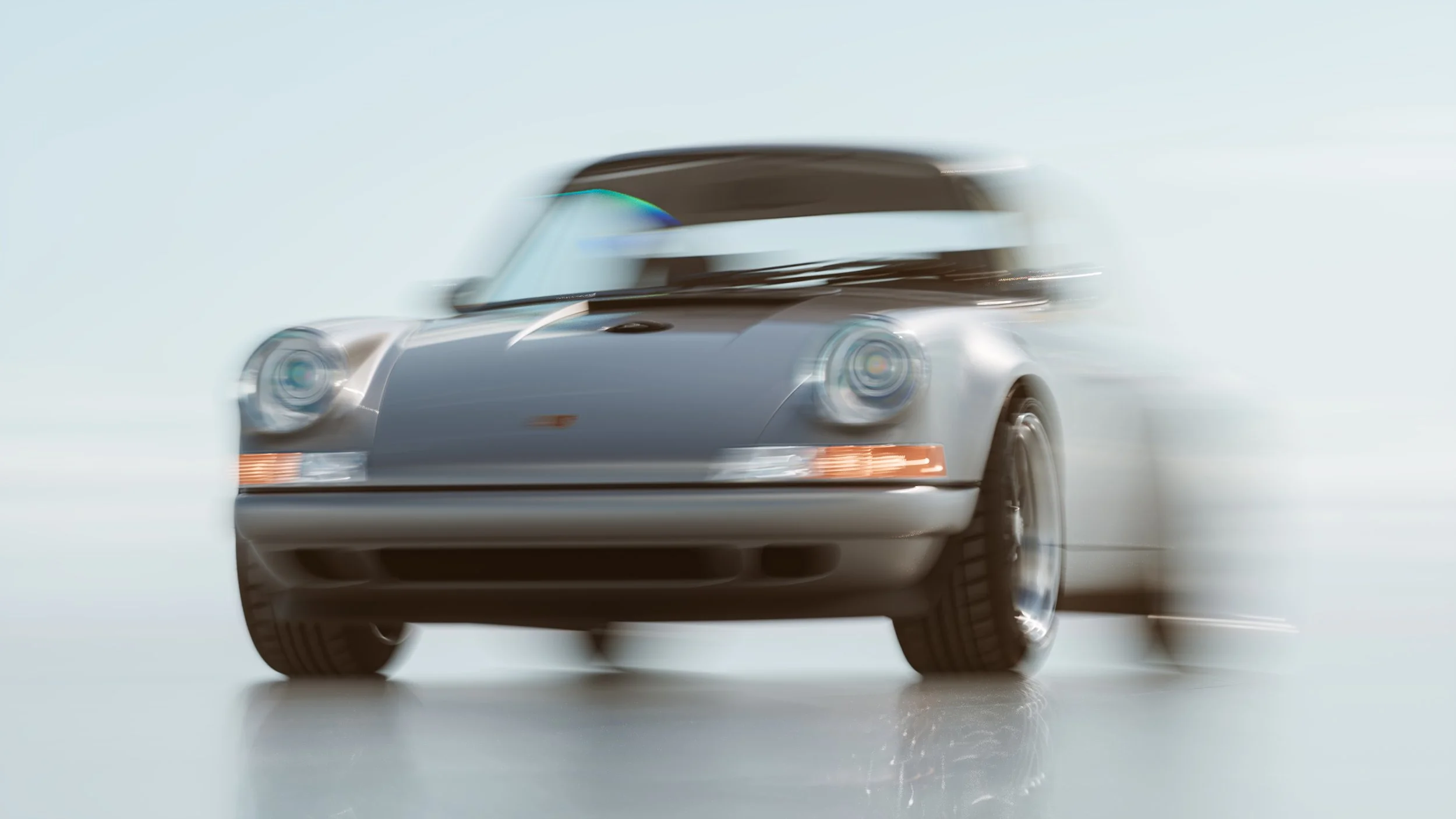 Blurred motion shot of a sleek, vintage-style sports car driving on a smooth surface.