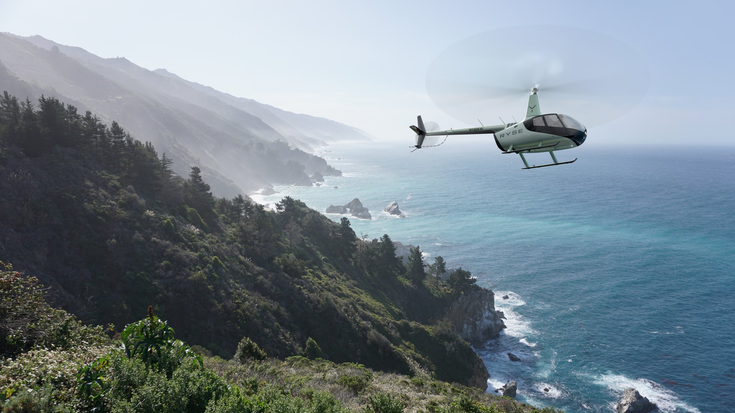 Helicopter flying over a coastal landscape with cliffs, trees, and the ocean in the background.