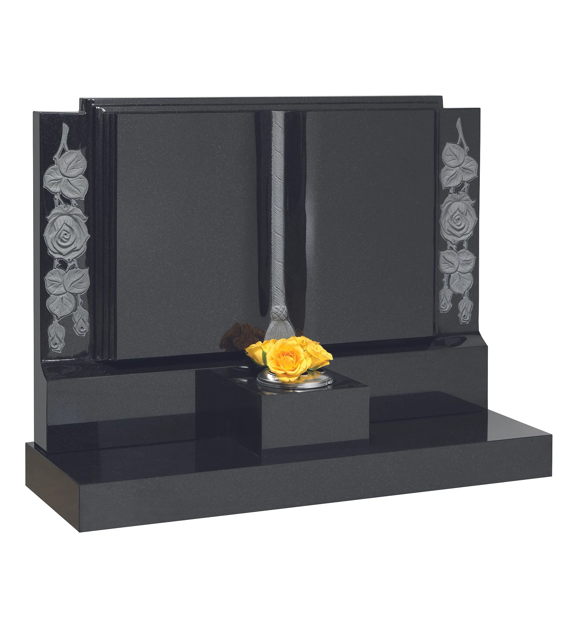 Black granite tombstone with engraved roses and a yellow rose arrangement at the base.