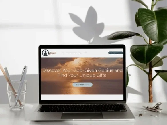 Laptop displaying a website with text "Discover Your God-Given Genius and Find Your Unique Gifts"; nearby are a glass with pencils and a potted plant.