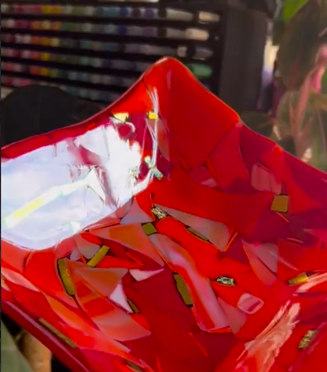 A fused glass candy dish in vibrant red