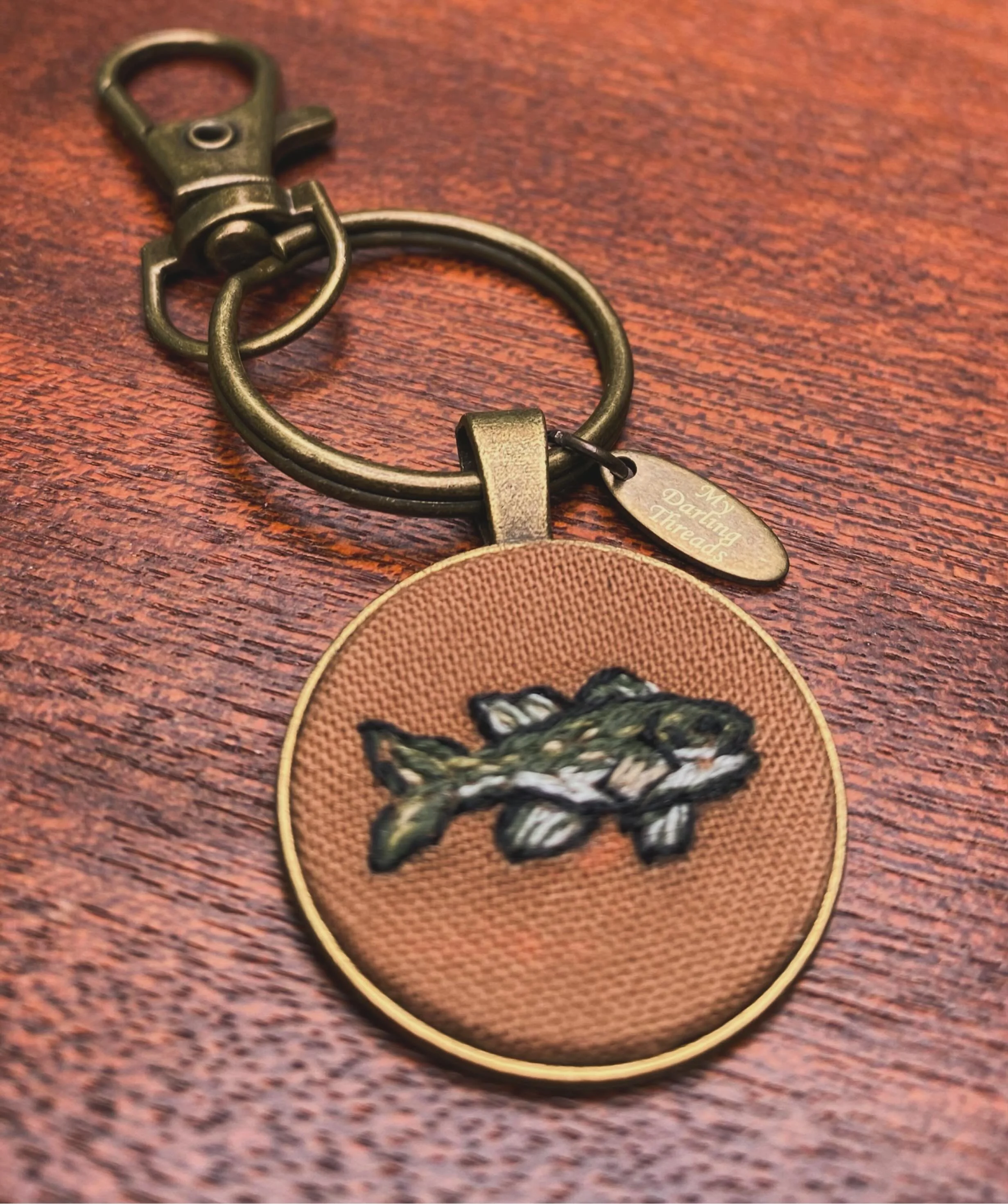 Little bass keychain I embroidered for my dad&rsquo;s birthday! Thinking I&rsquo;ll whip up a few of these for my next market on Father&rsquo;s Day weekend @ciderhill_farm 🎣🍎