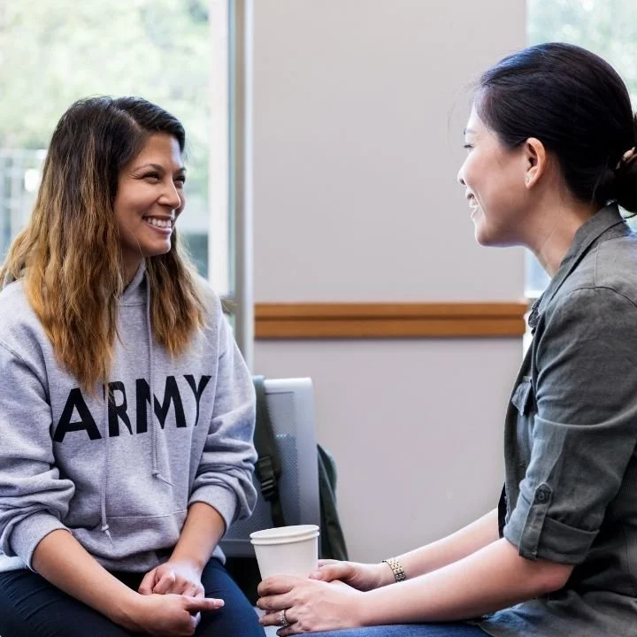 Female therapist and patient smiling and talking during a session