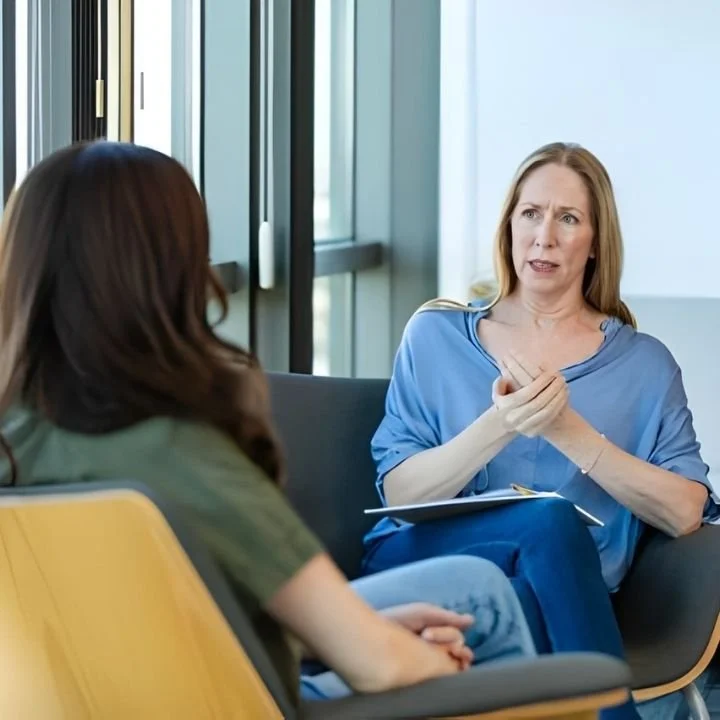 Therapist speaking with client during one-on-one counseling session.