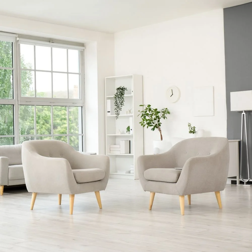 Bright and modern therapy room with two beige armchairs facing each other