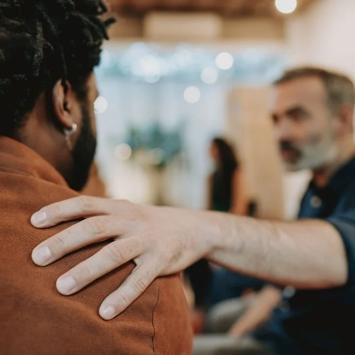 Therapist offering supportive reassurance during CBT session for OCD intrusive thoughts.