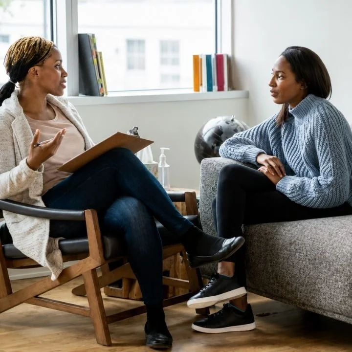 Woman listening attentively while speaking with a therapist.