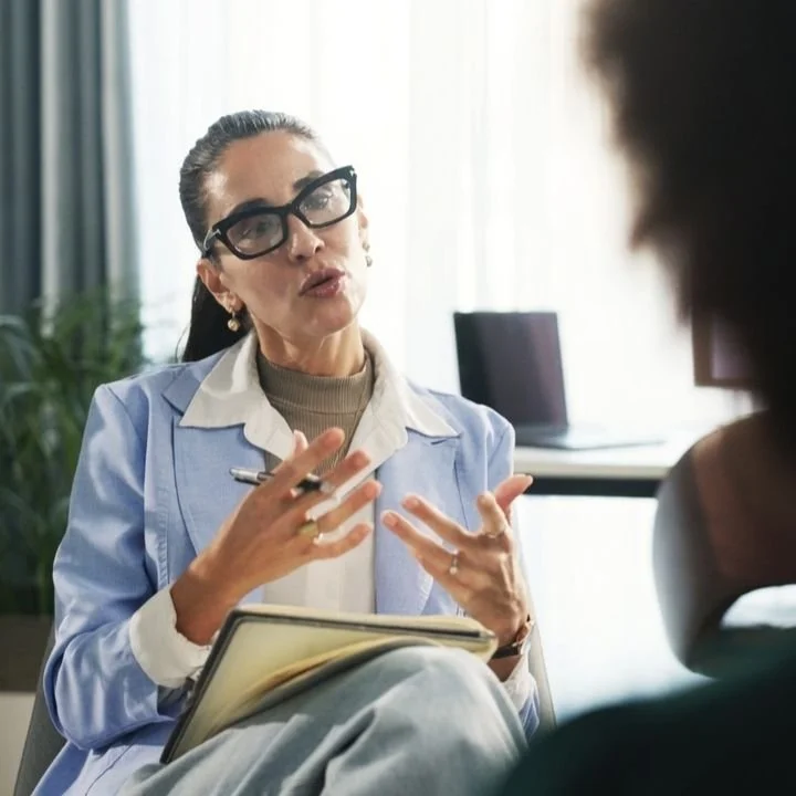 Therapist explaining how EMDR helps process traumatic memories during a counseling session.