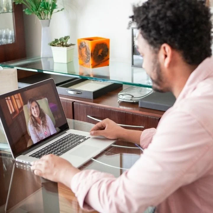 Man speaking with a therapist during an online EMDR session.