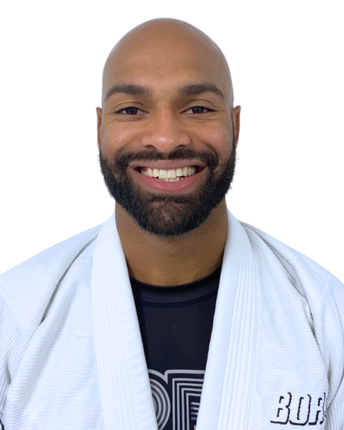 Coach Shaquille Gordon smiling in his white Bora gi