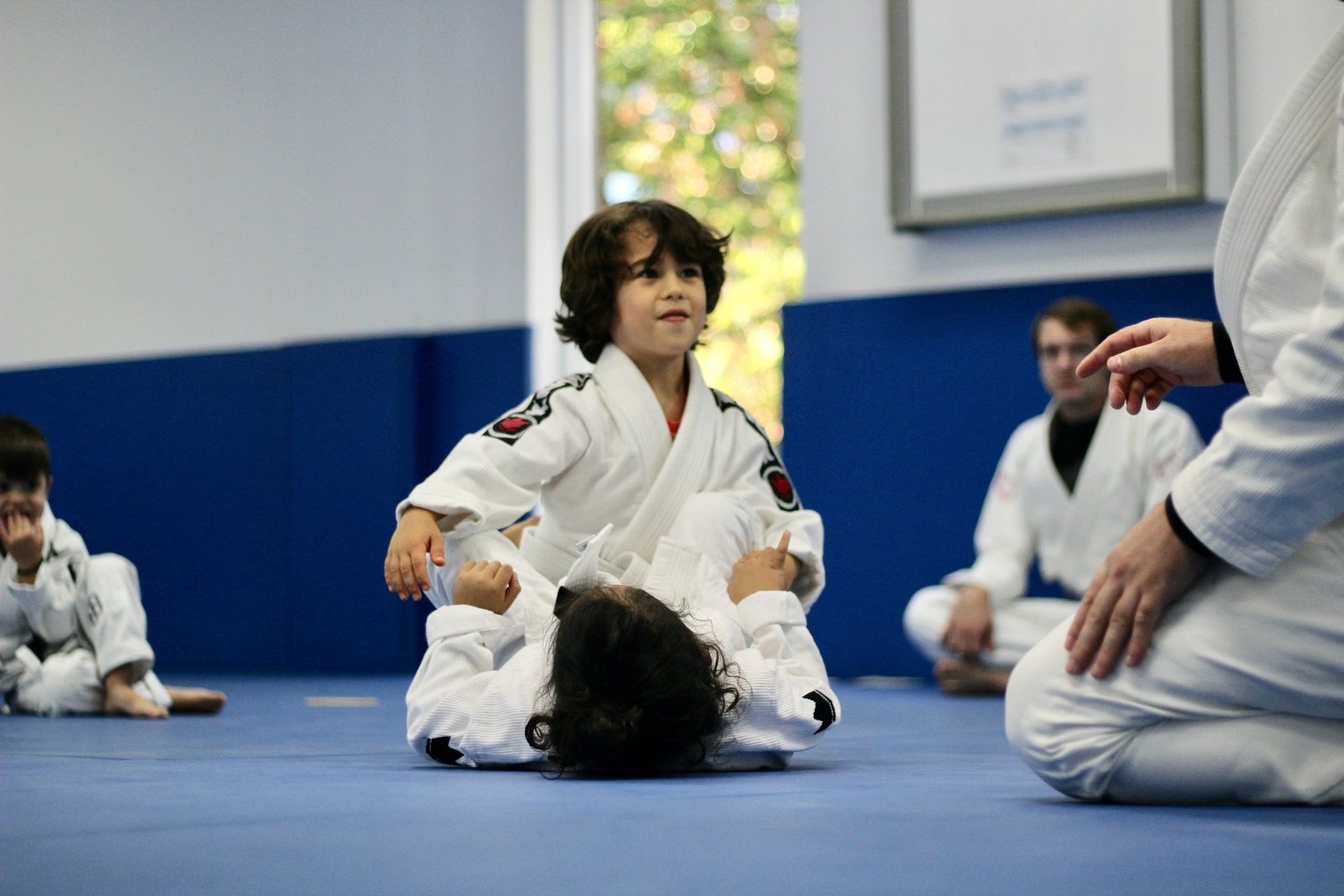 A child paying attention during a Jiu-Jitsu demonstration
