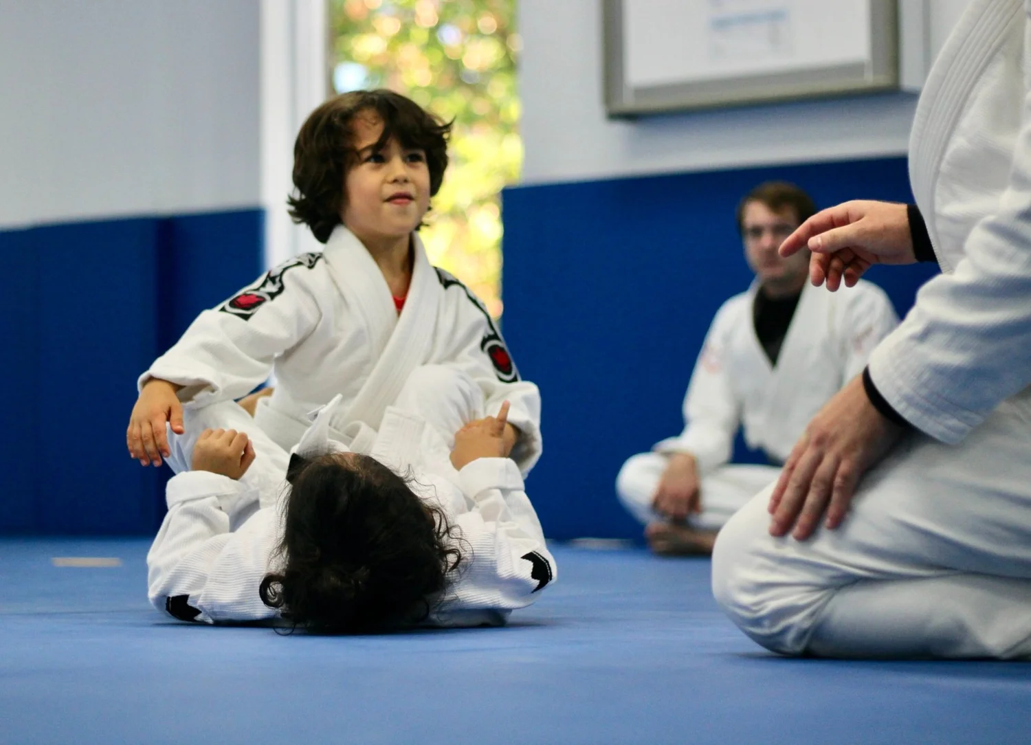 A child watching a technique demonstration at Bora