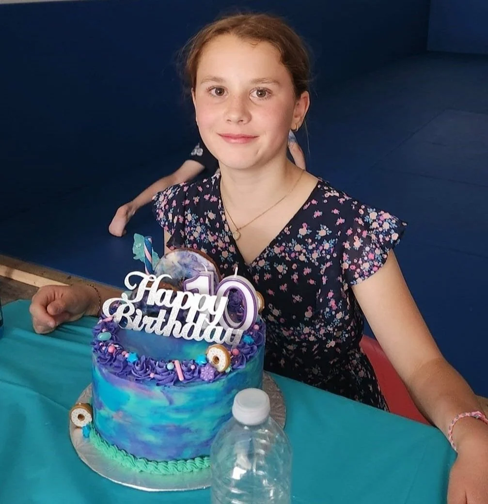 A child celebrating a birthday with a cake at Bora