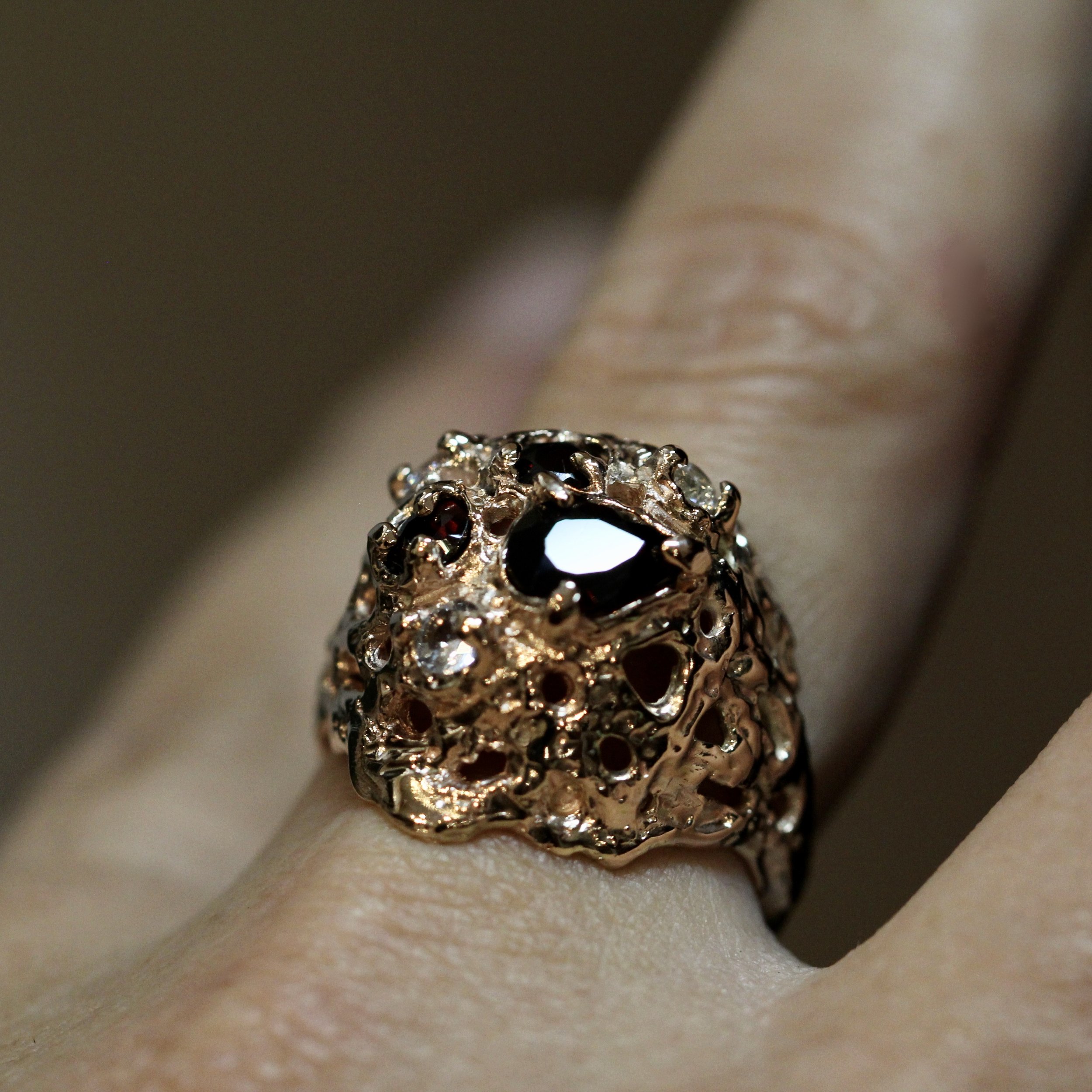 Repurposed gold and pyrope garnet with added white sapphires
