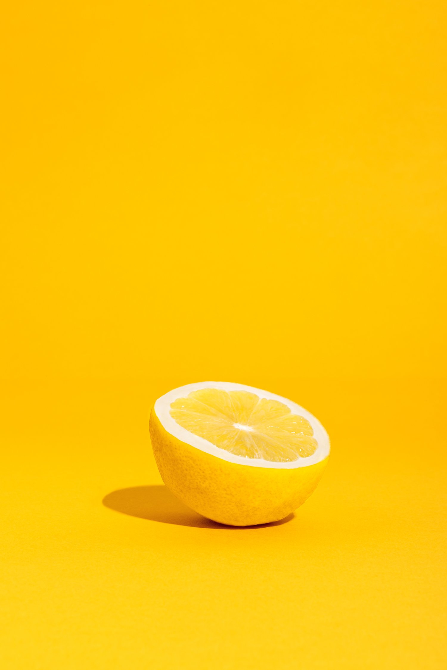 Demi-citron sur fond jaune vif.