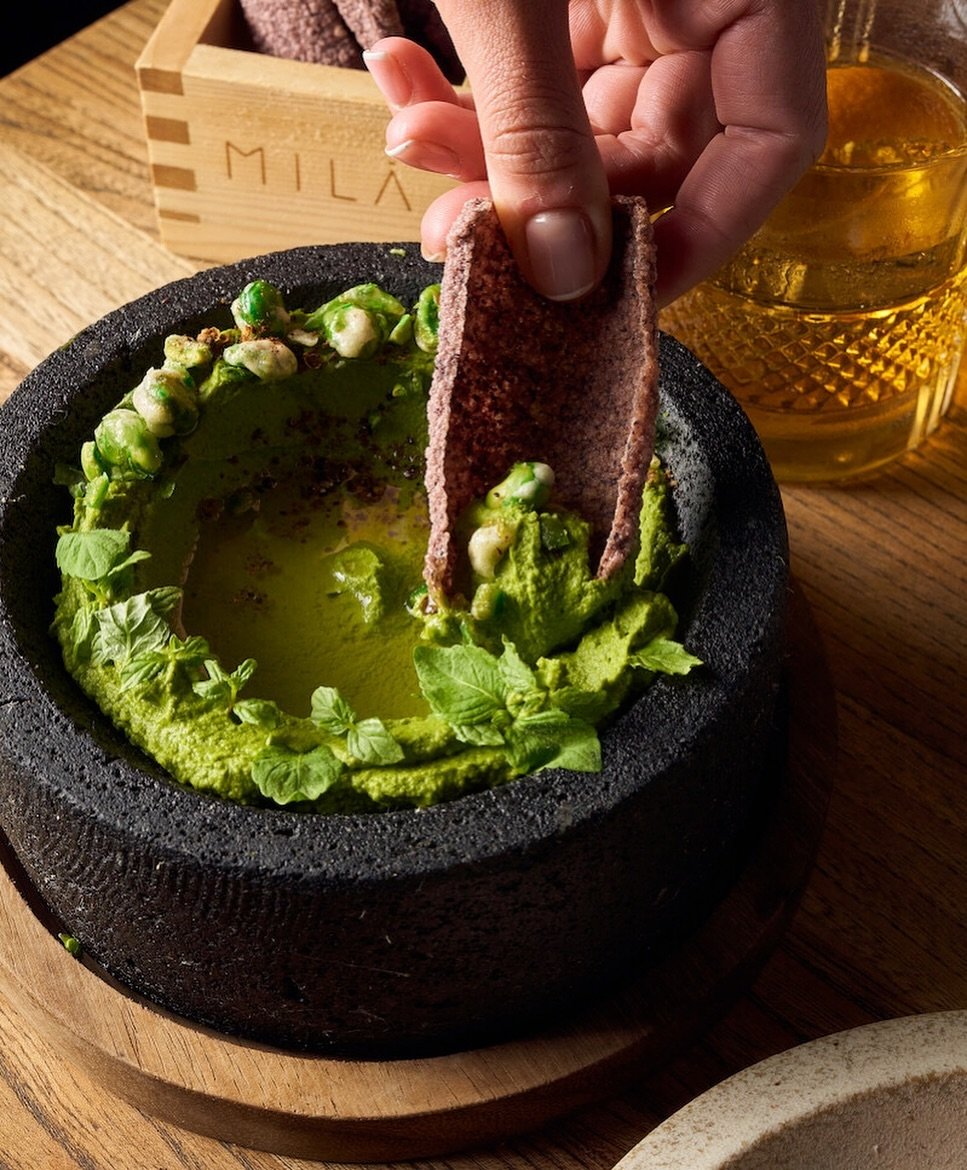 Explore the flavors of MILA&rsquo;s Edamame Hummus, a creamy blend topped with spicy wasabi peas and complemented by the crunch of our black rice crackers. See you soon at #MILArestaurants