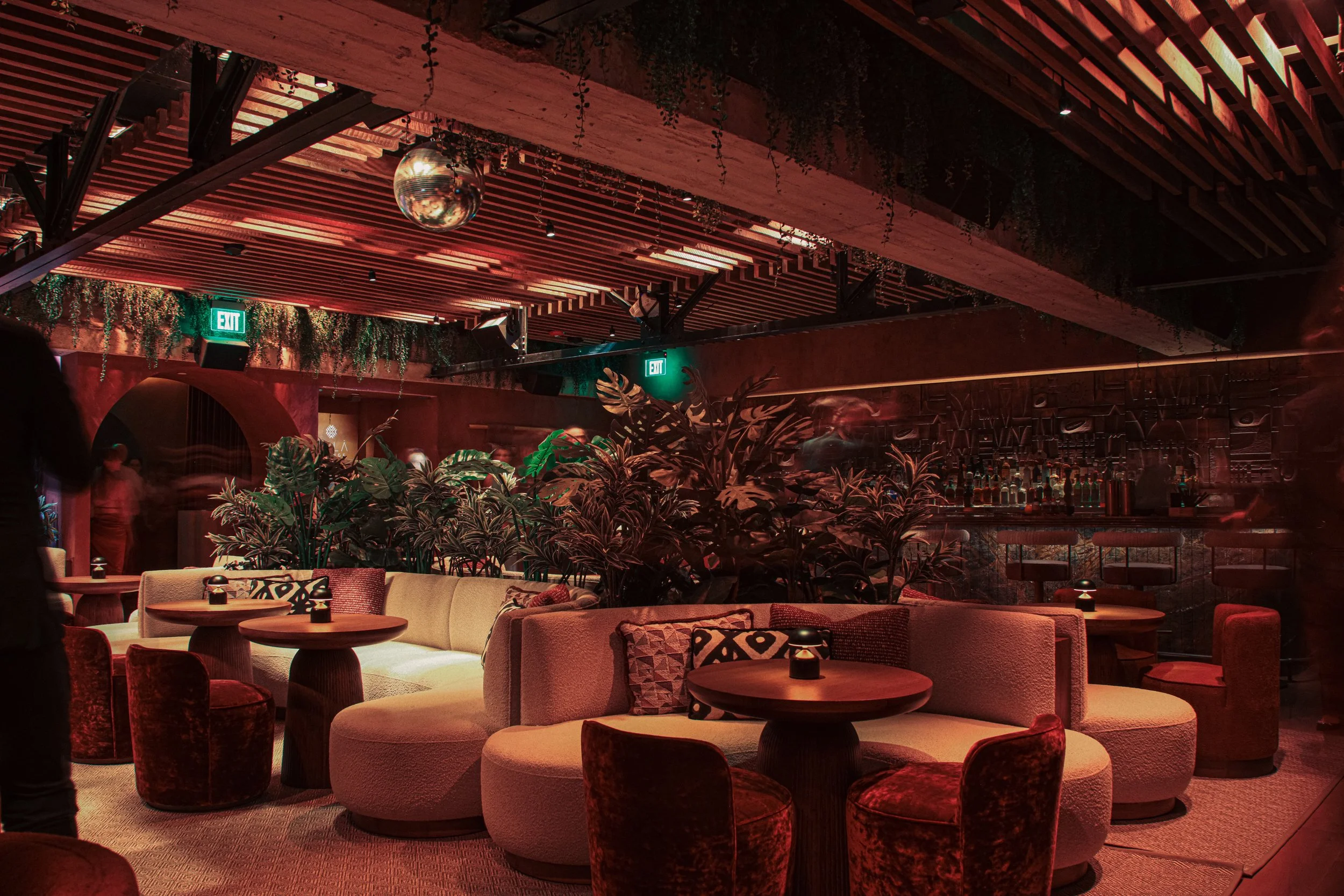 MILA lounge with round booths, and a bar in the background.