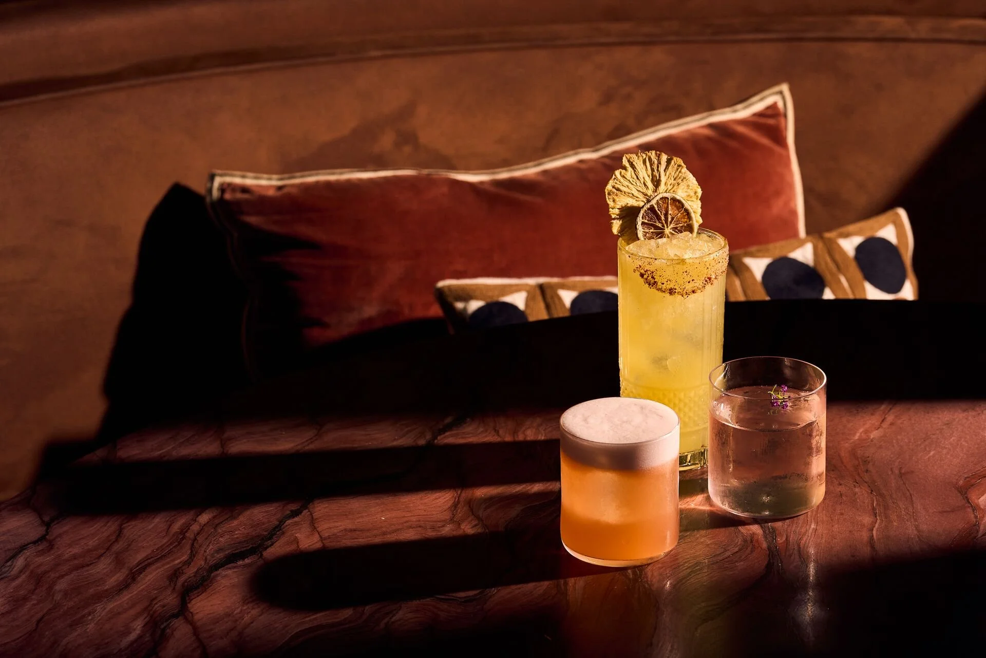 Three refreshing cocktails served during golden hour at MILA.