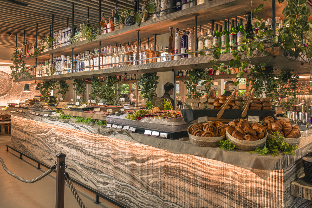 Brunch buffet layout with inside MILA with an assortment of foods and drinks