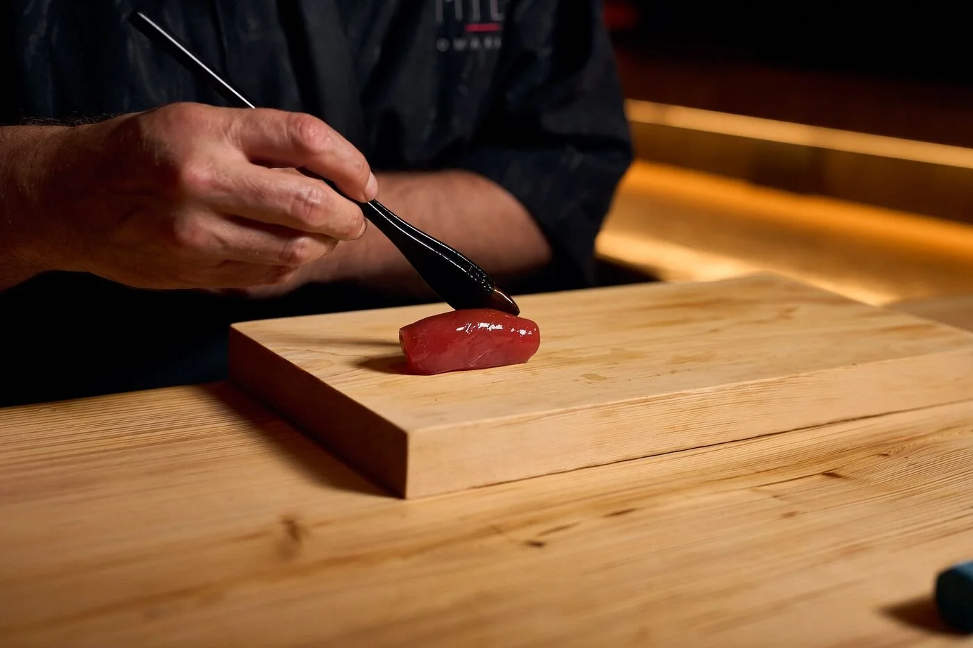 One of MILA Omakase's chef preparing a dish.