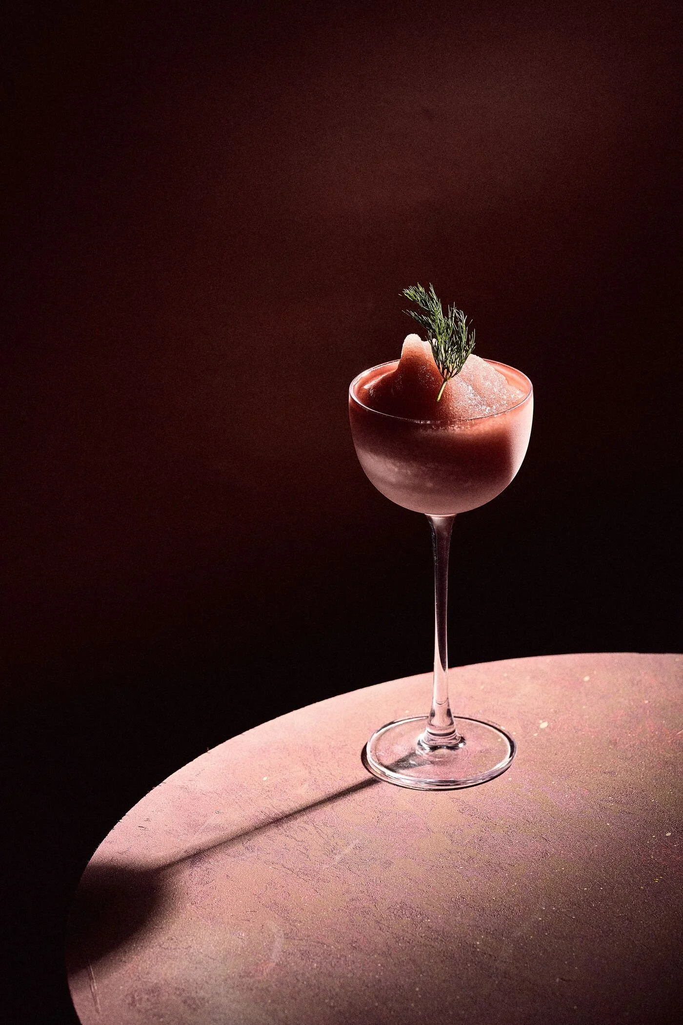 One of MILA's cocktails, with a green garnish.
