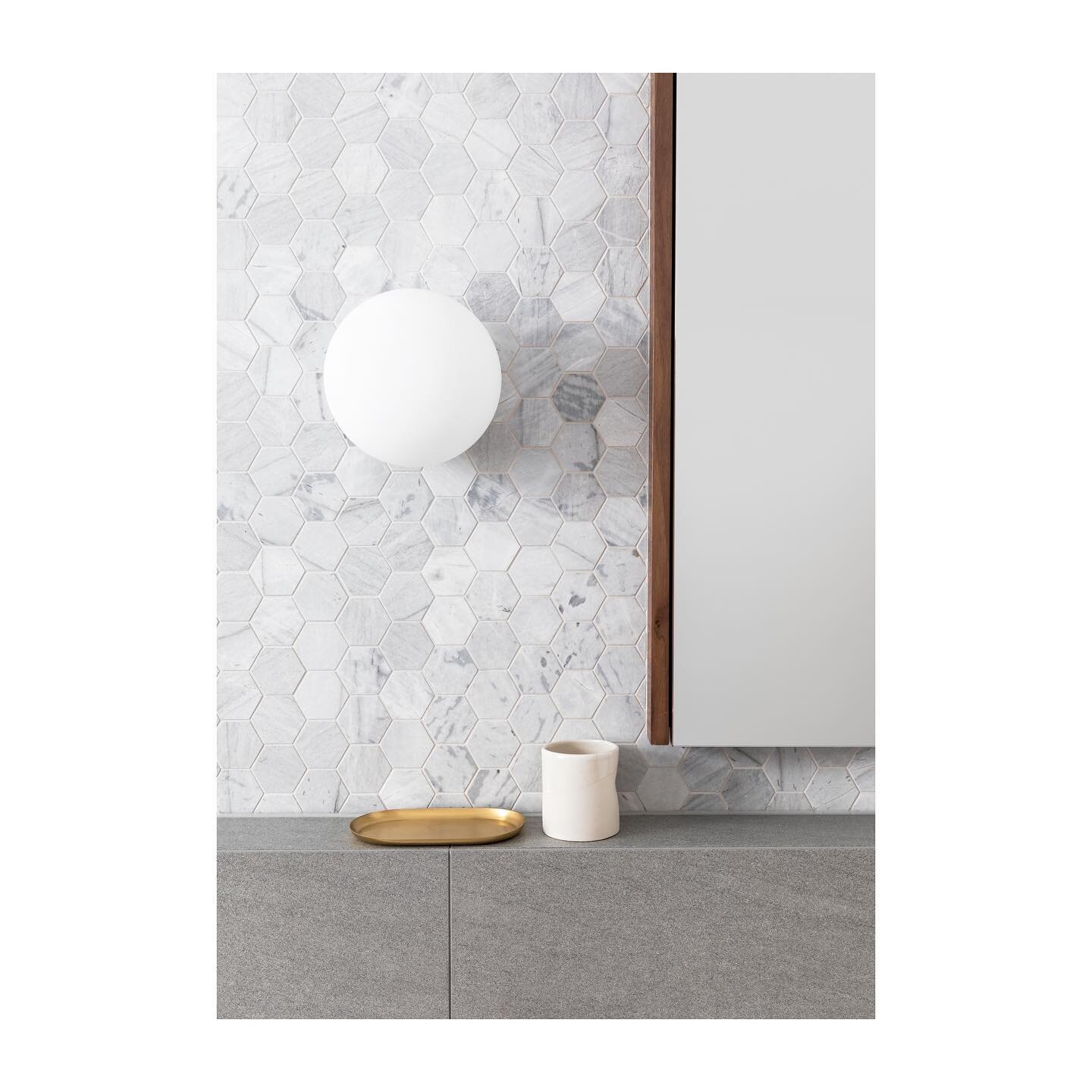 The bathroom&rsquo;s interior design palette was selected to harmonise with the kitchen, by implementing tiles in the same Elba marble. The contemporary hexagon shape was a nod to the federation era of the original home. 

Architecture &amp; Interior