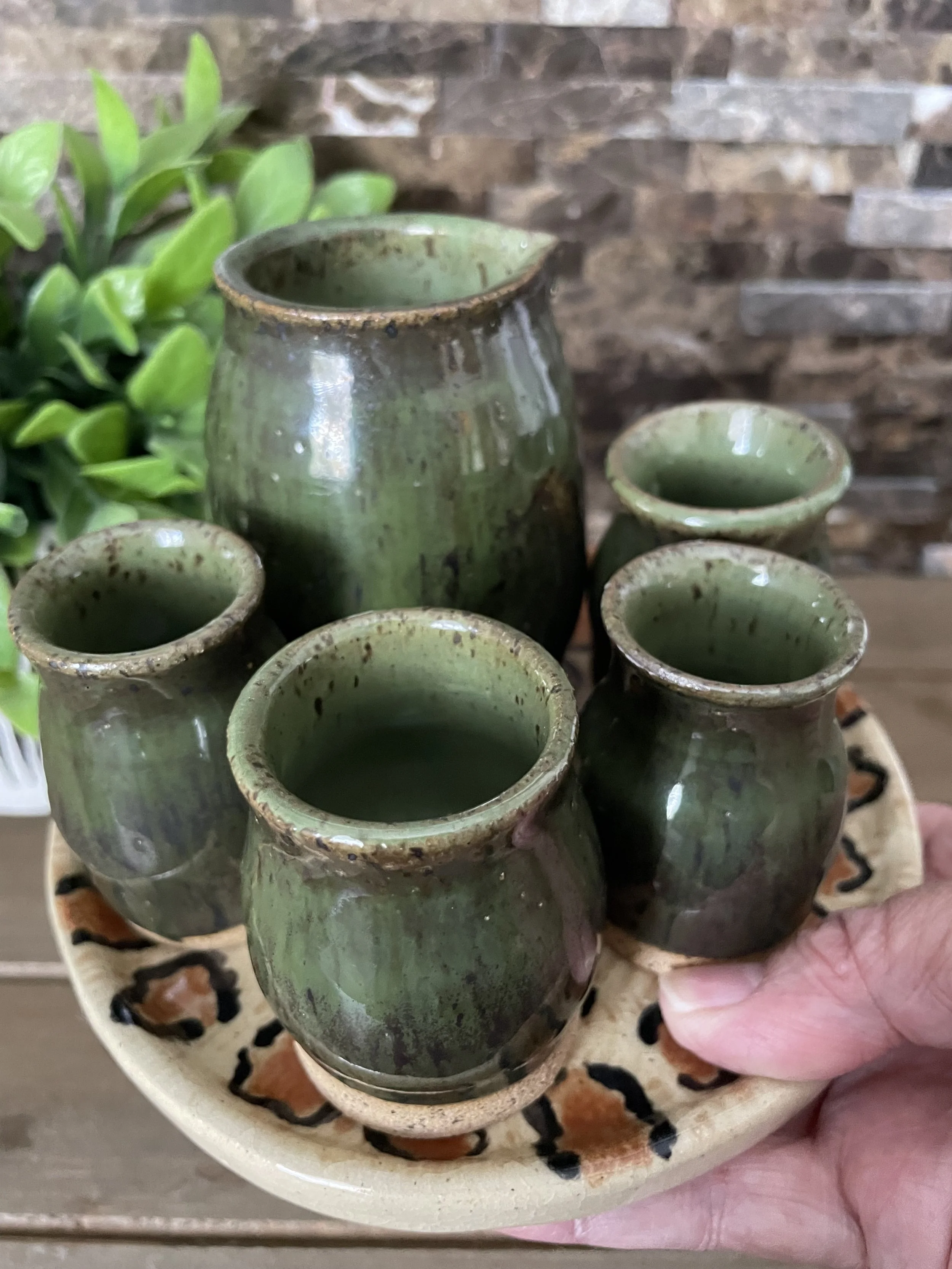 Unique Sake set. 4 shot glasses each slightly different but complementary to set. Thumb indentation for easy crisp pouring.