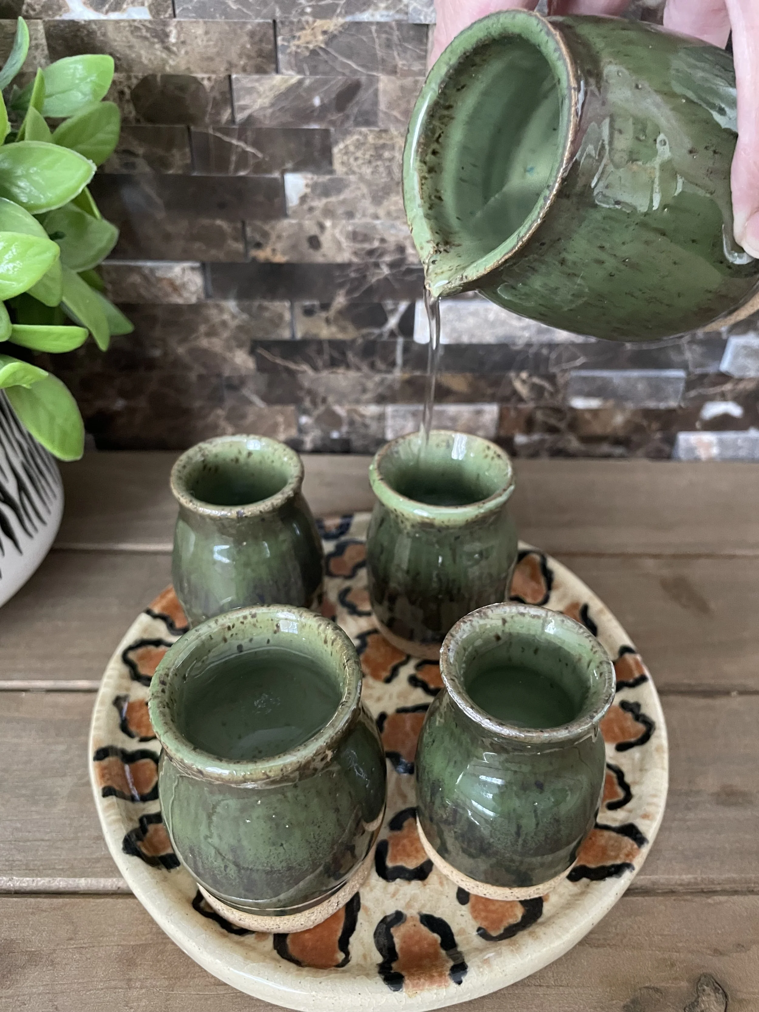 Unique Sake set. 4 shot glasses each slightly different but complementary to set. Thumb indentation for easy crisp pouring.