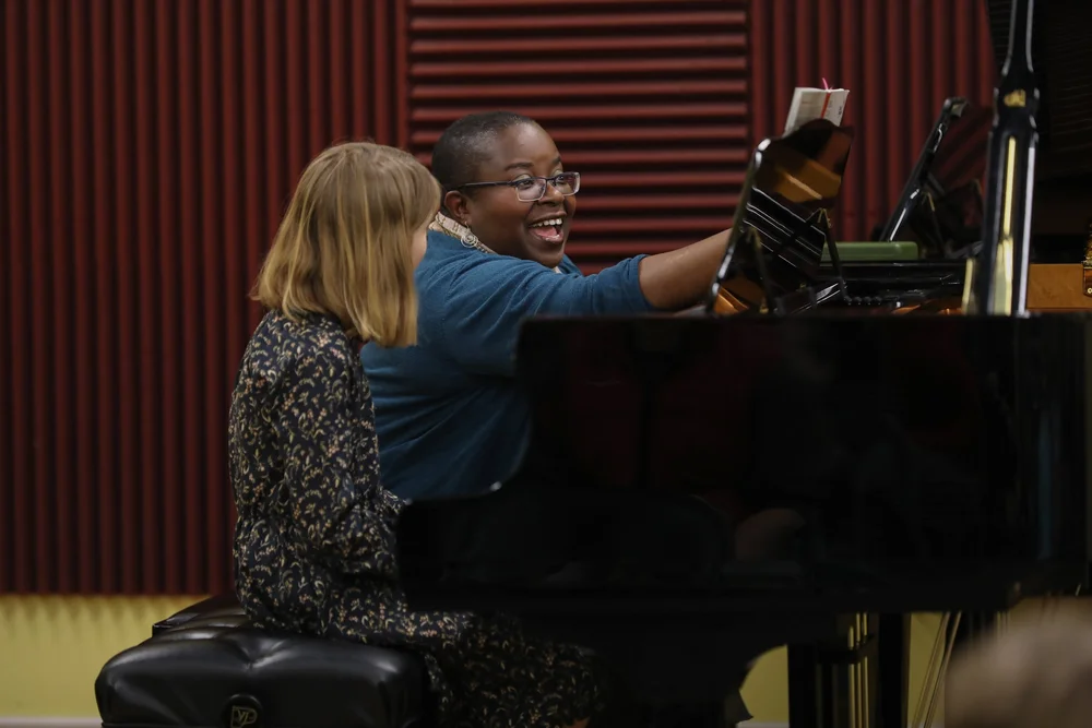 Nnenna Ogwo coaching a student at the piano
