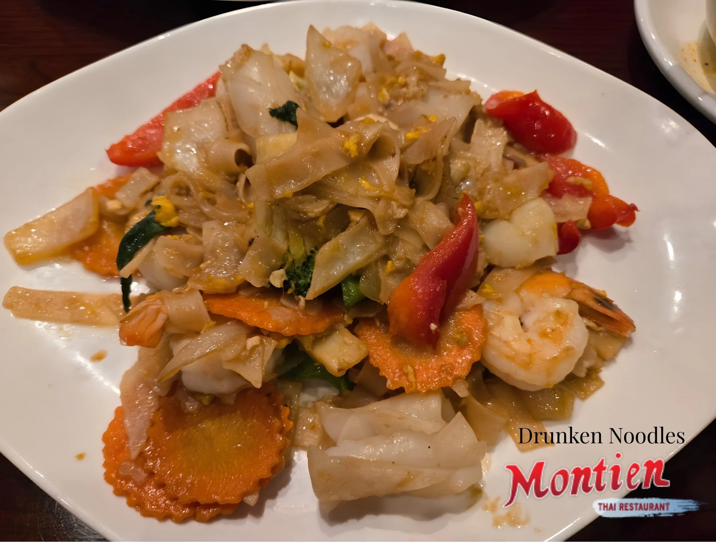 Drunken Noodles, Stir Fried Flat Noodles w/ Egg Onions Bamboo Shoots Carrot Broccoli Green Beans Baby Corn Red & Green Peppers in Spicy Basil Sauce. Best Drunken Noodles in Boston!