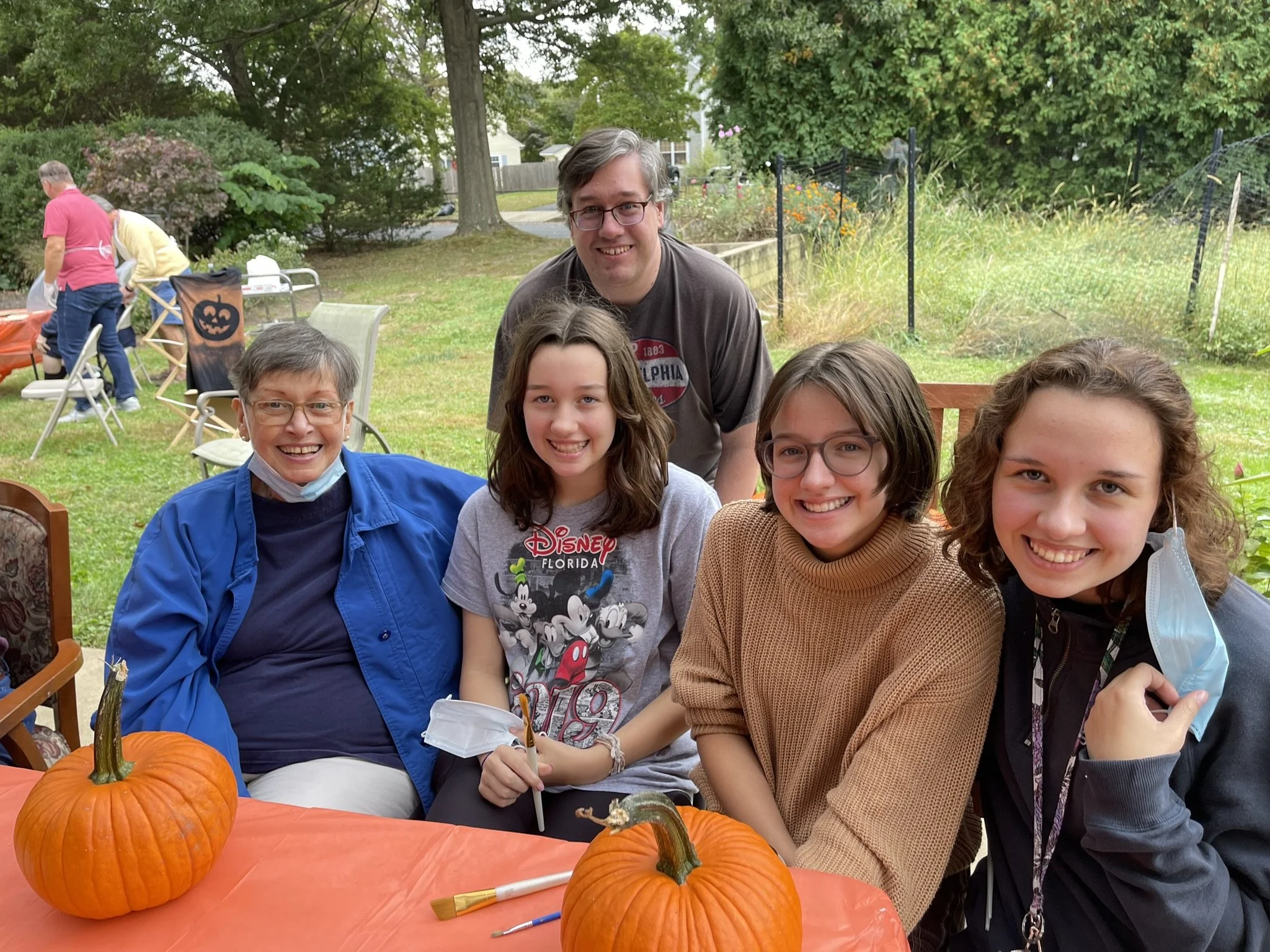 Friends Village residents and volunteers participating in an outdoor community activity in Newtown, PA