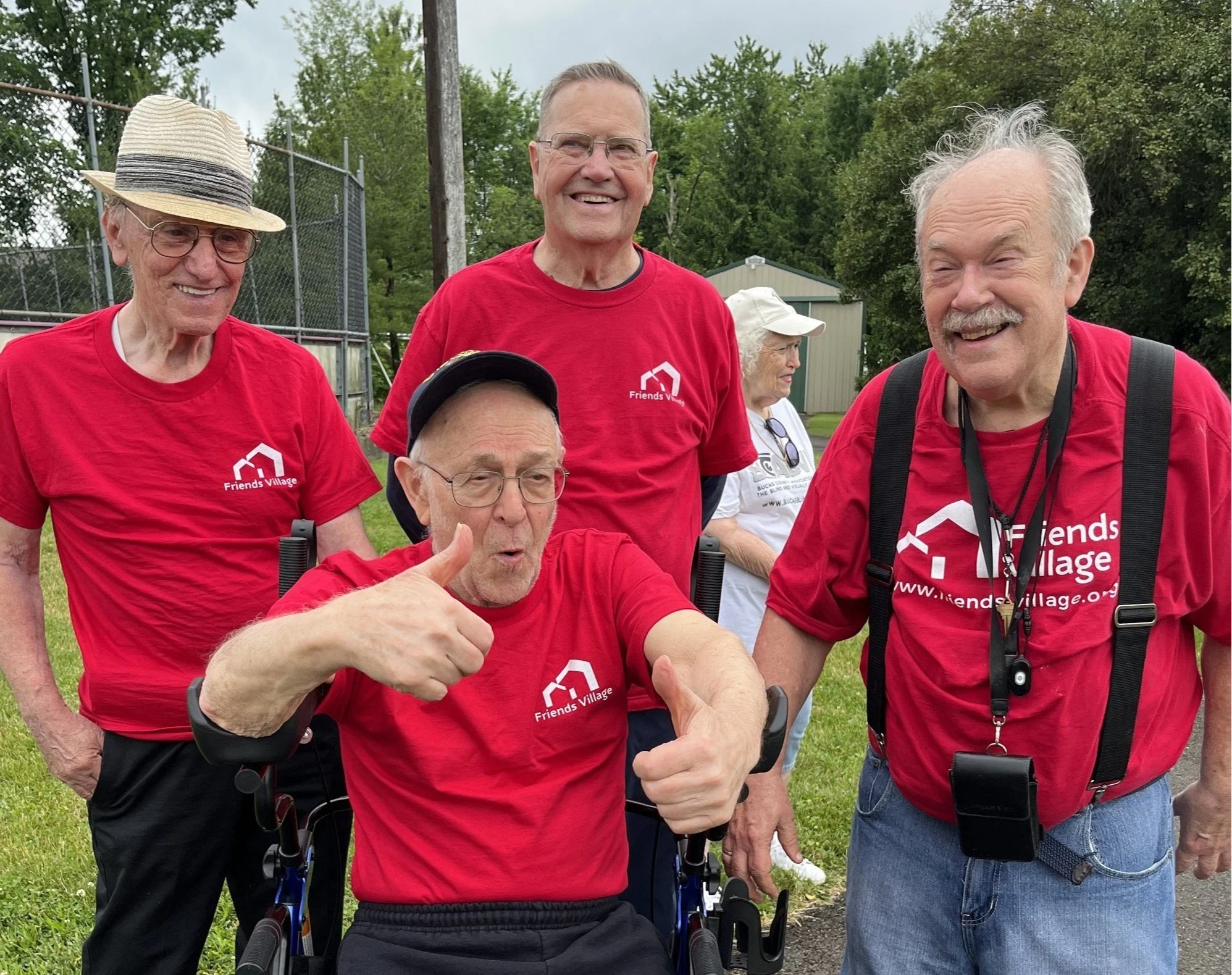Two residents walking through a labyrinth on a sunny day.