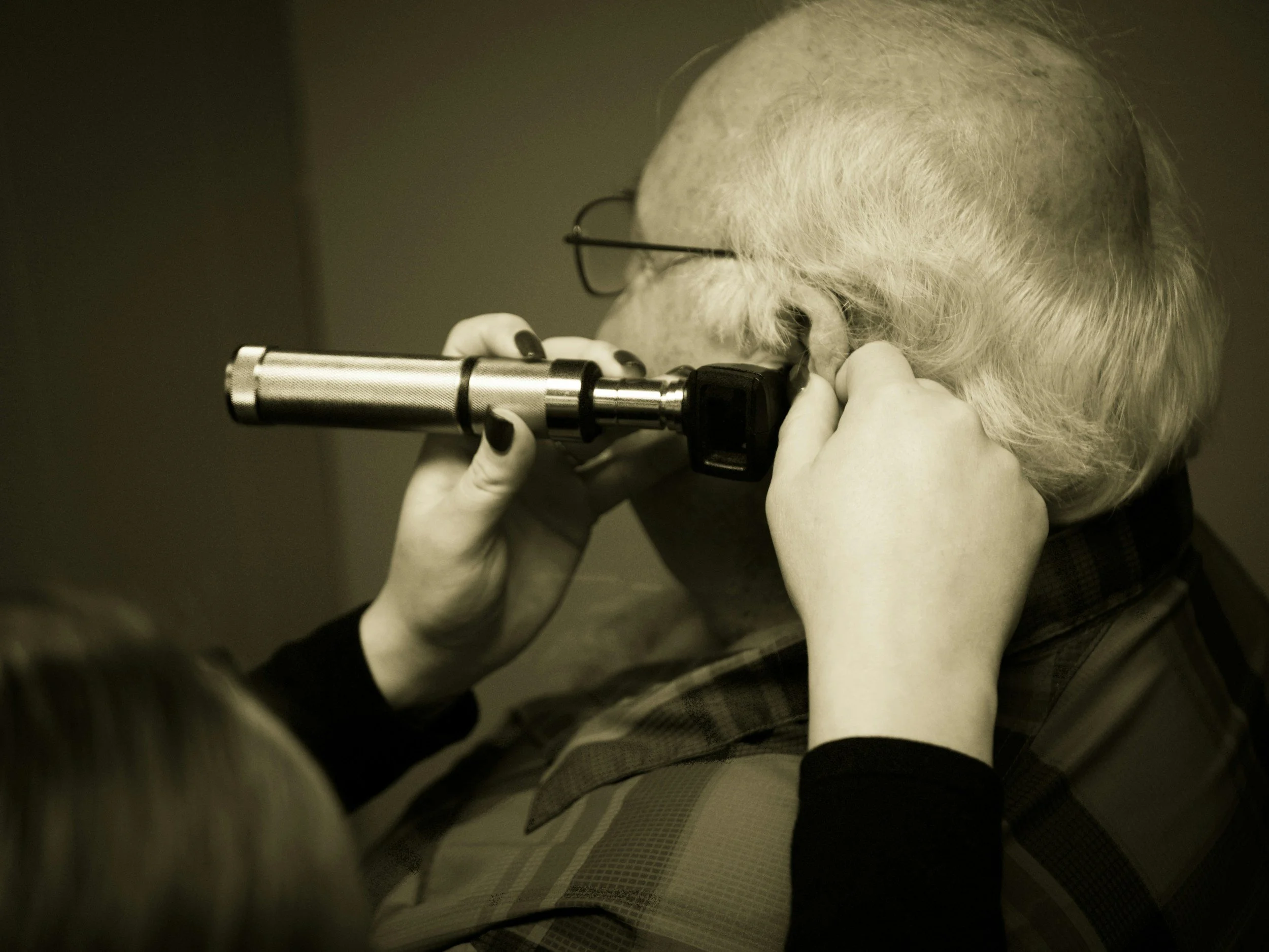 Older adult receiving a hearing screening to check for hearing loss and support healthy aging