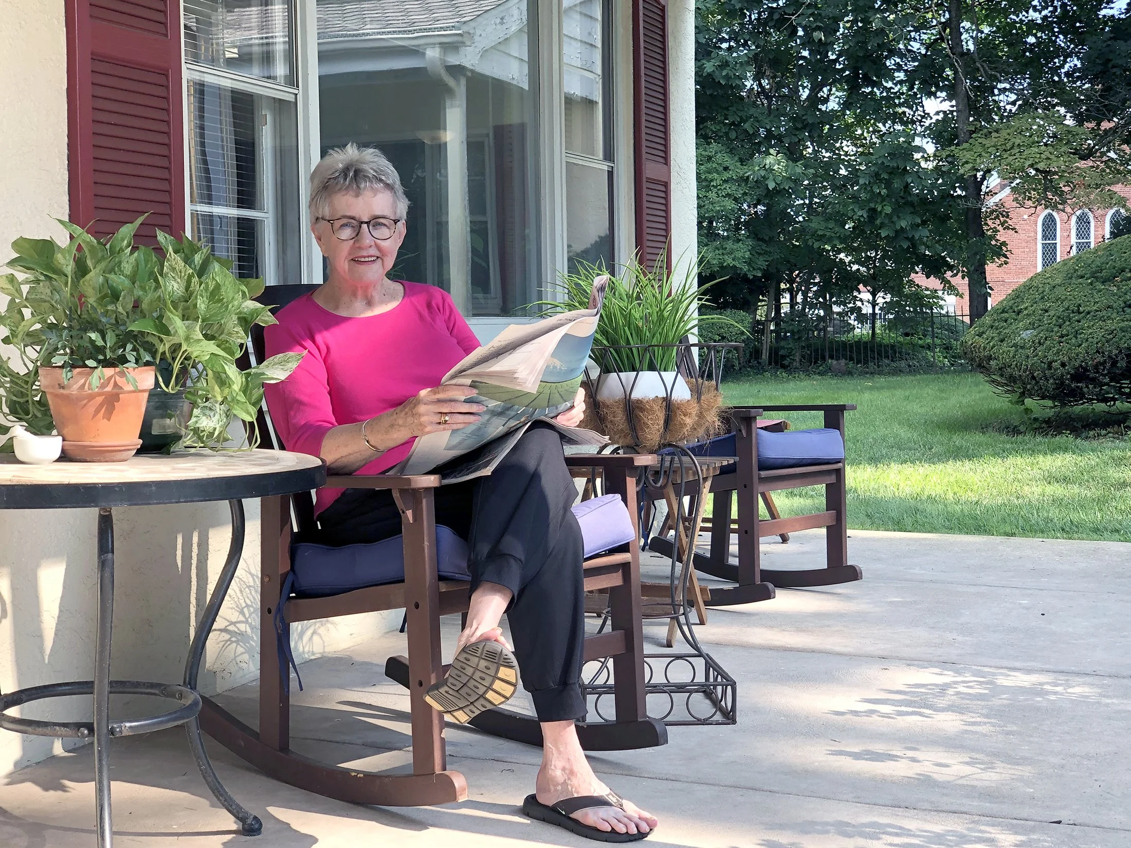 Friends Village resident reading outside on a patio in Newtown, PA