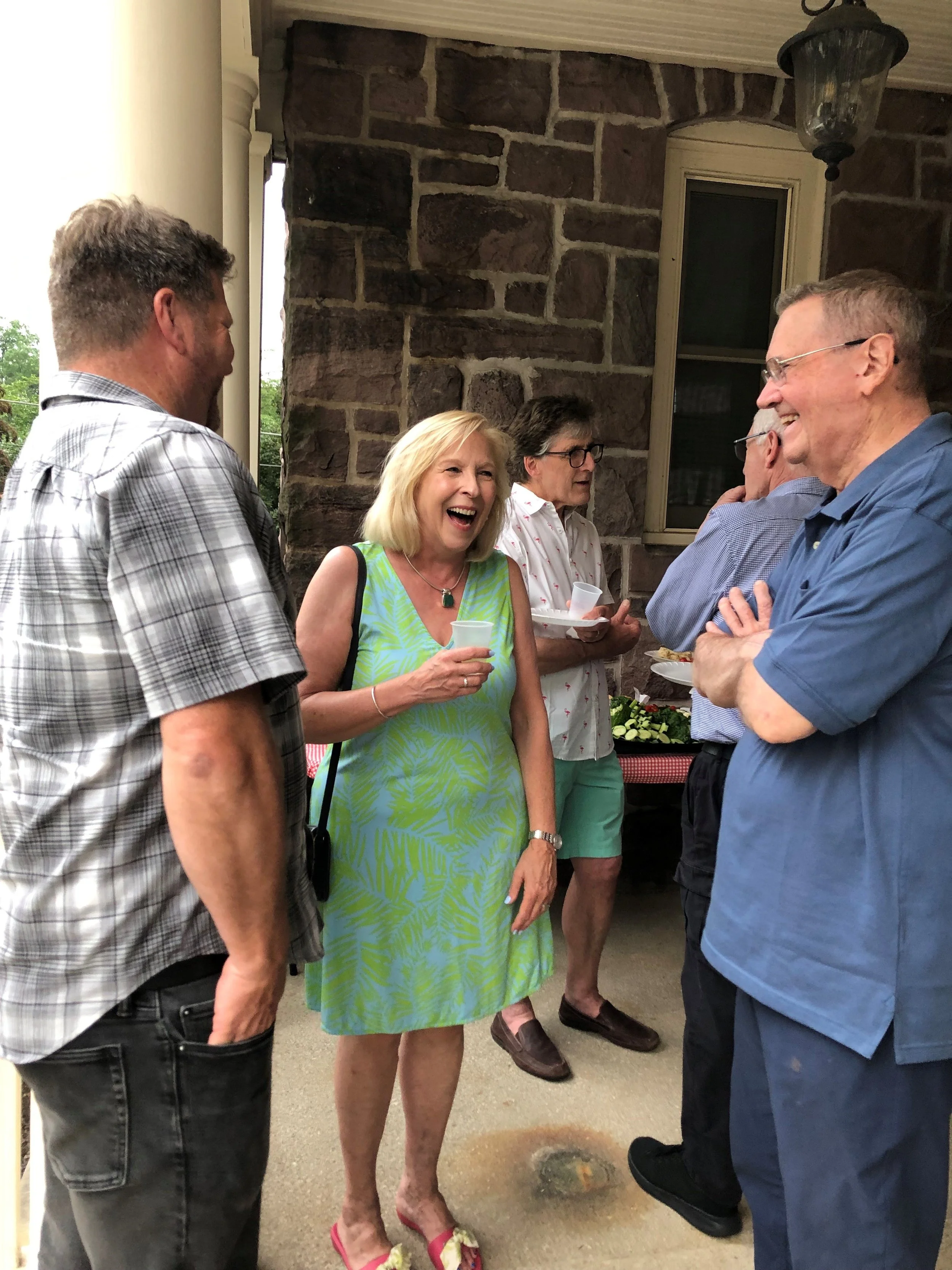 Renee Pettys speaking with attendees during Newtown Porchfest at Friends Village