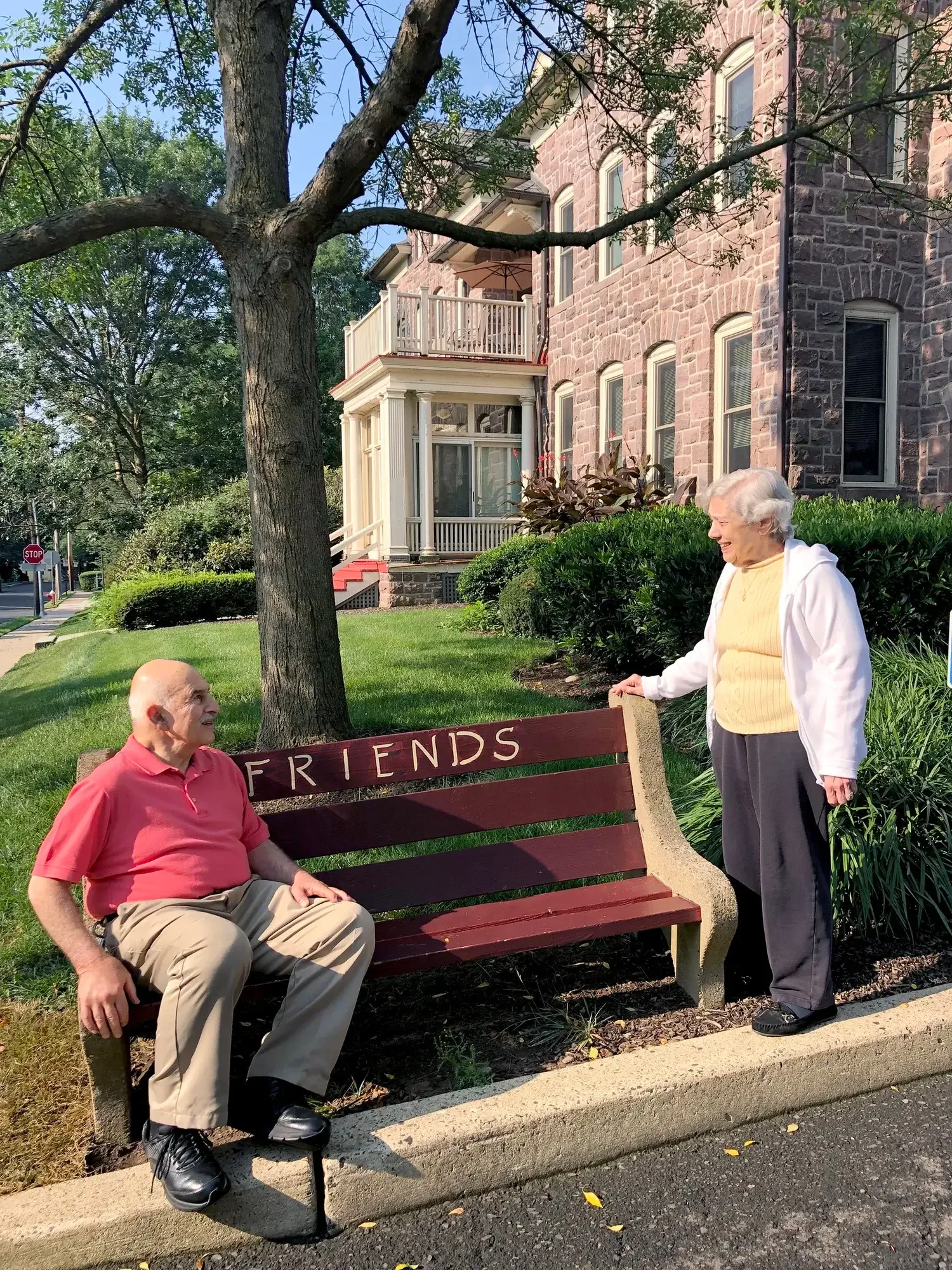 Residents sitting on a bench and chatting.