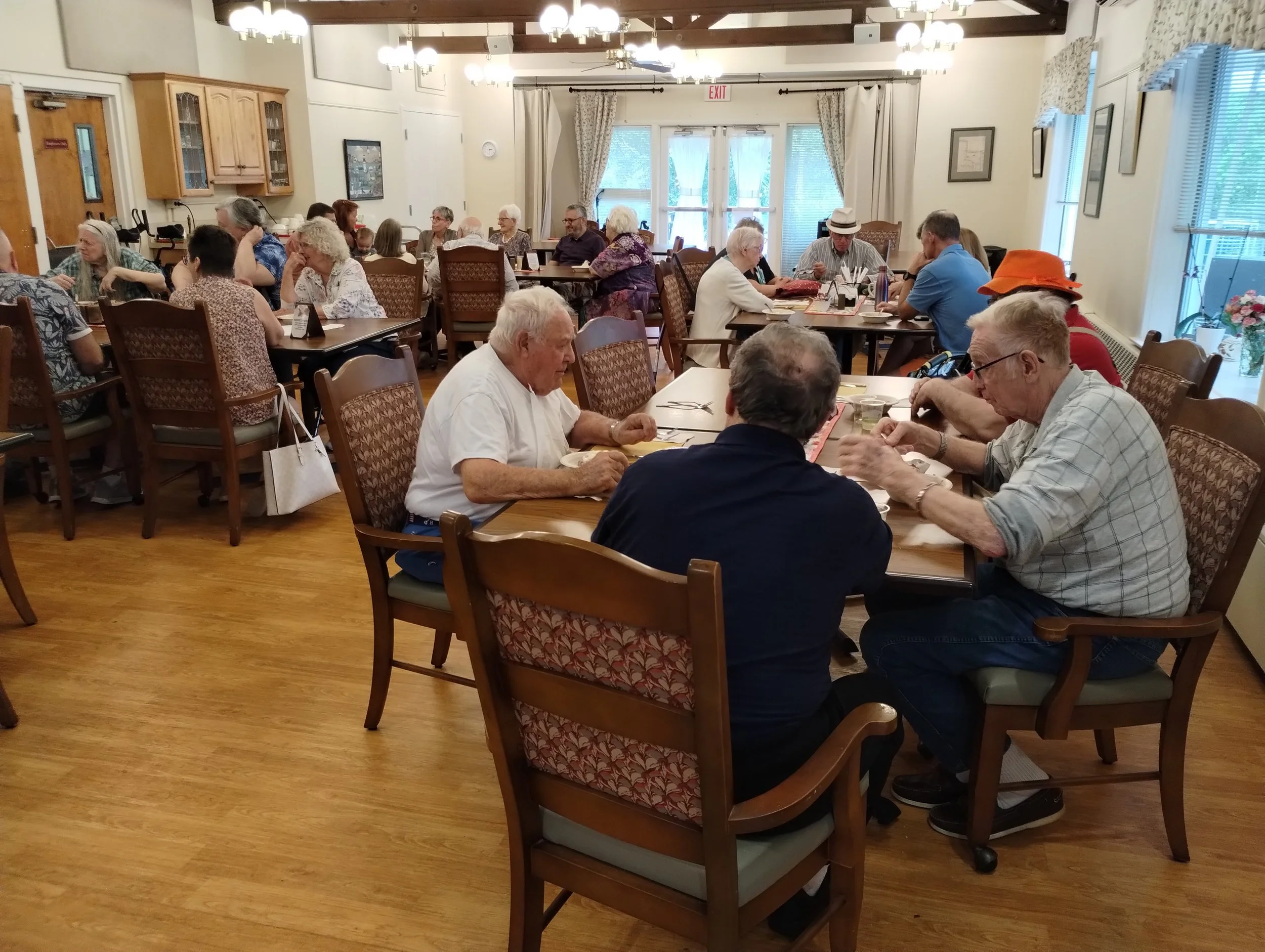 Friends Village residents sharing a meal in a senior living community dining room in Newtown, PA