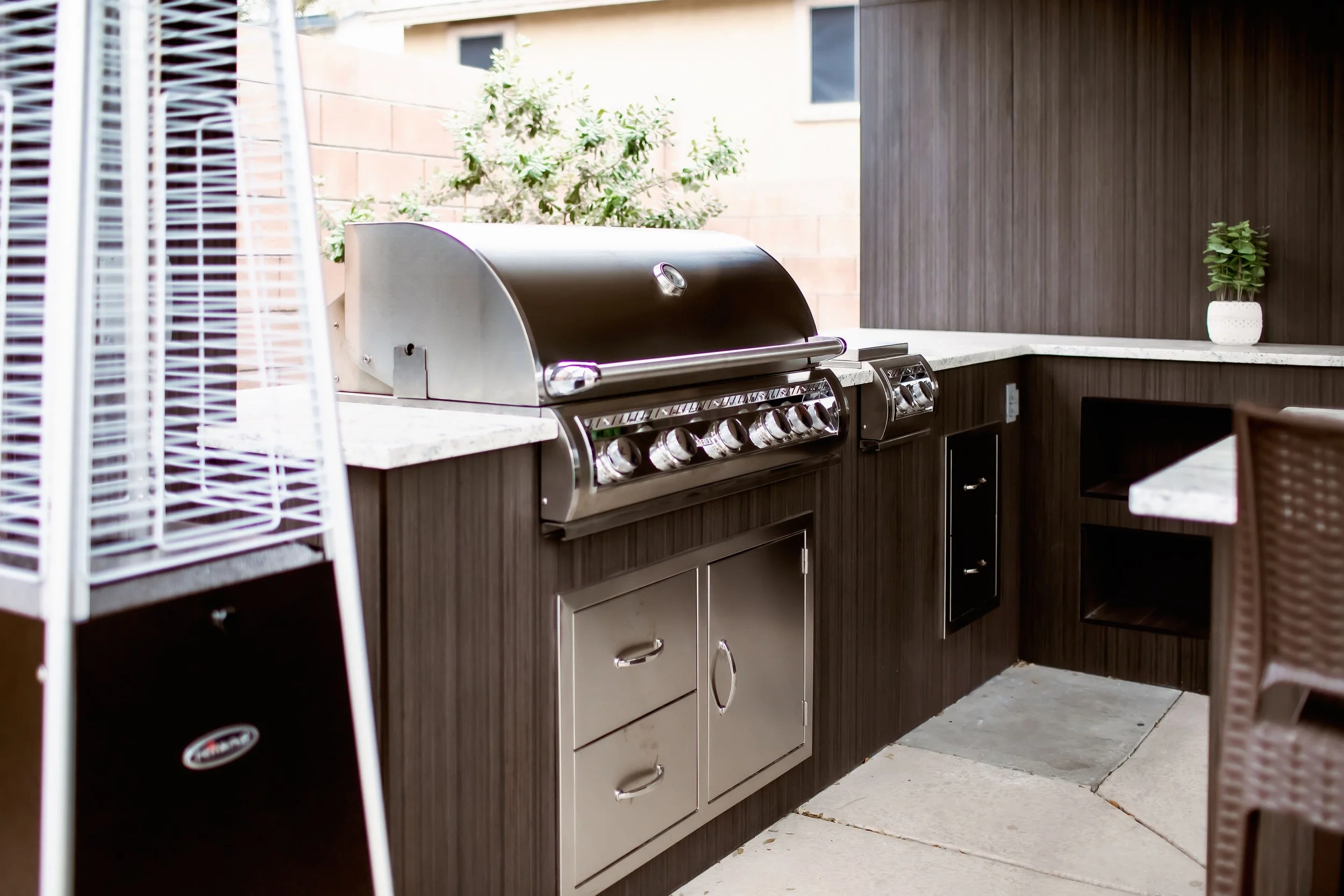 Outdoor kitchen with stainless steel grill and patio heater
