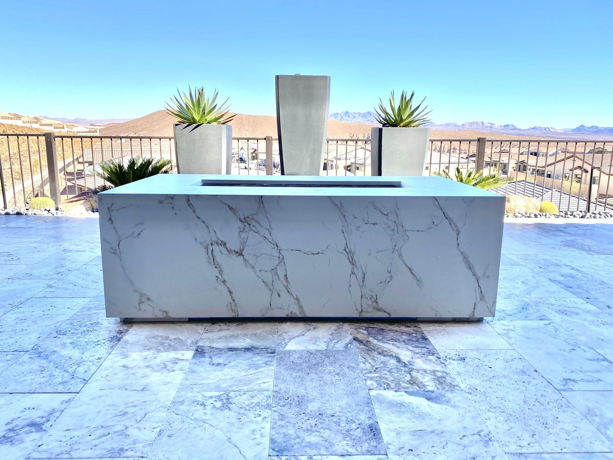 Modern patio with marble table and planters