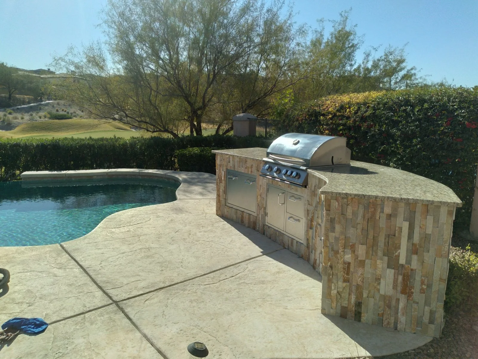Backyard with outdoor kitchen and pool