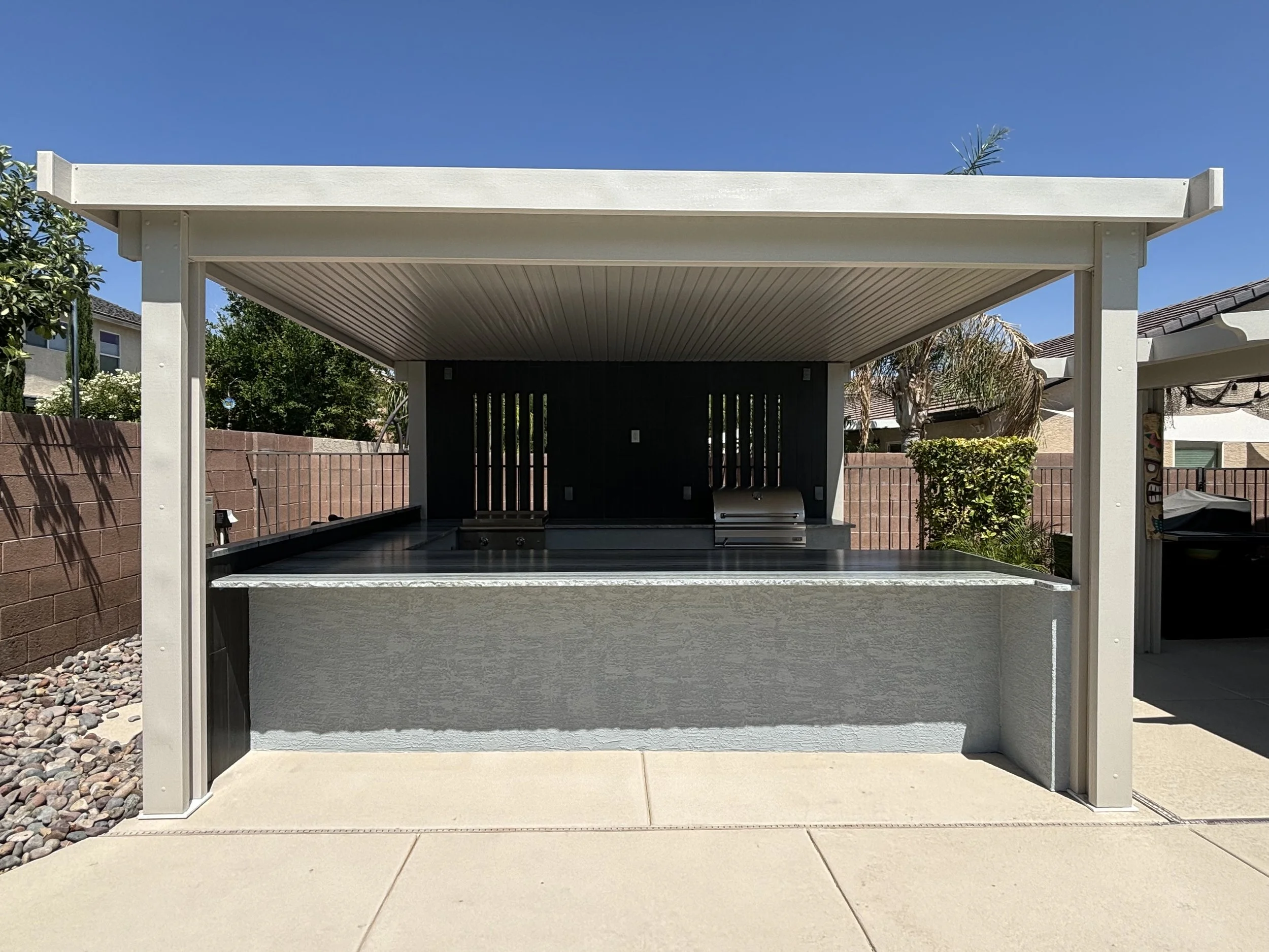 Outdoor covered patio with built-in grill and countertop