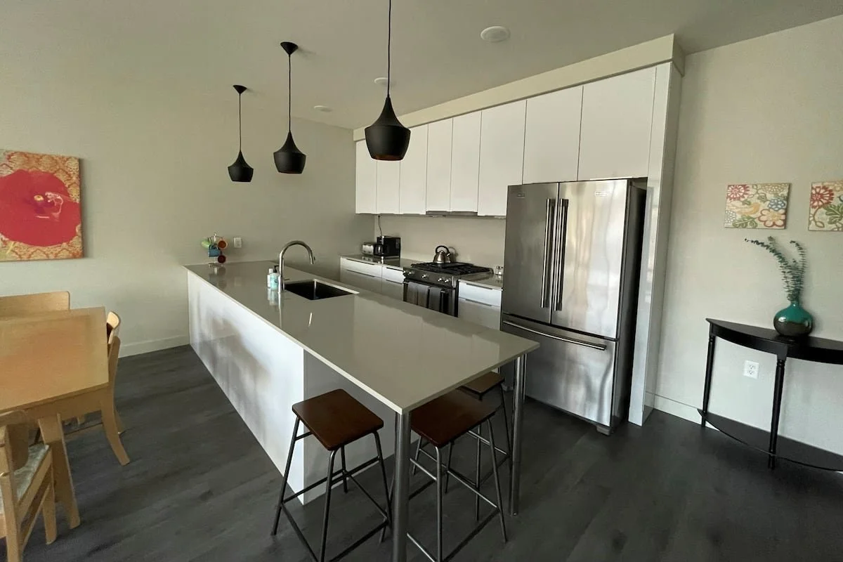 A full kitchen with island and stainless steel appliances.