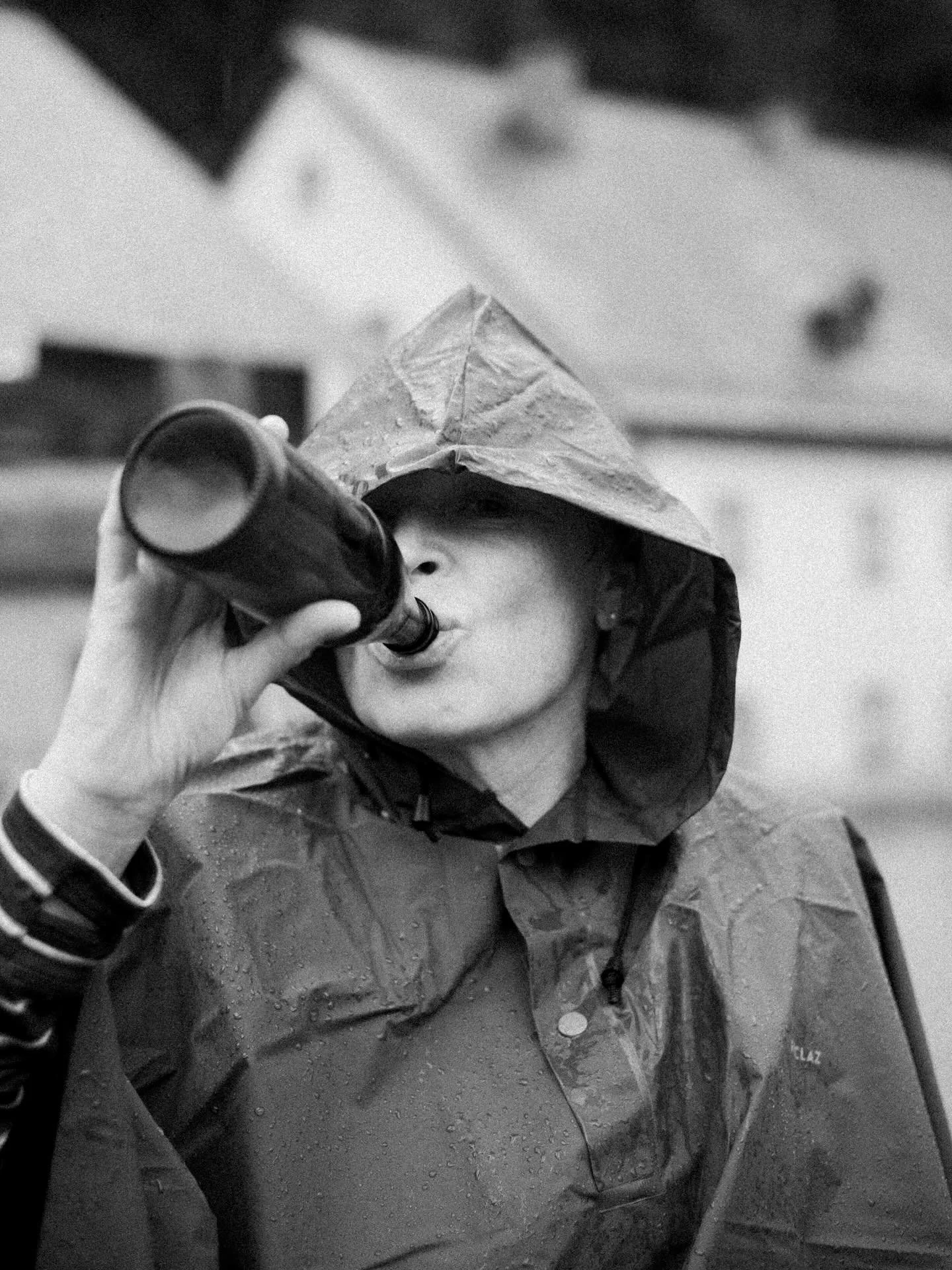 Mom chugging an Austrian lager in the rain.
