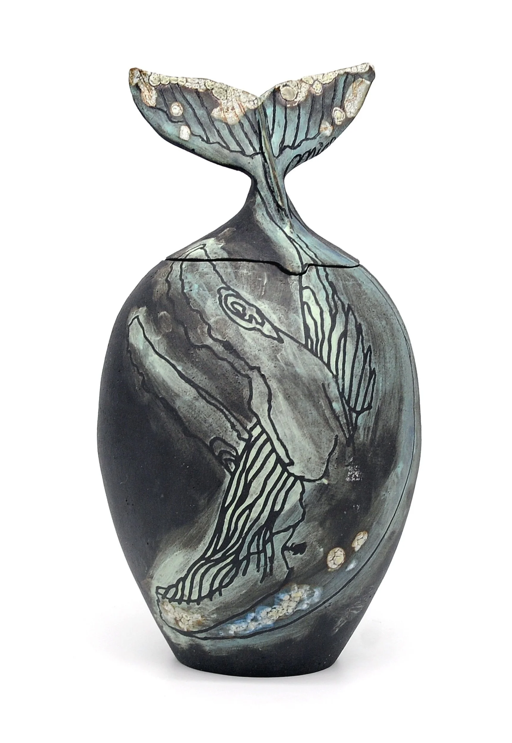 Decorative whale-shaped ceramic vase with intricate patterns and a tail-shaped lid.