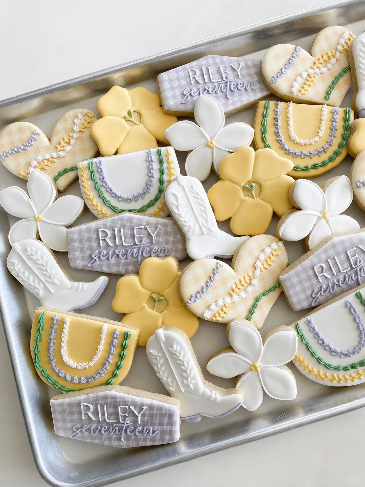 Local girl cookies for Riley&rsquo;s 17th 💜🤍💛
.
.
.
#hawaiicookies #oahucookies #leicookies #puakenikeni #cowgirlcookies