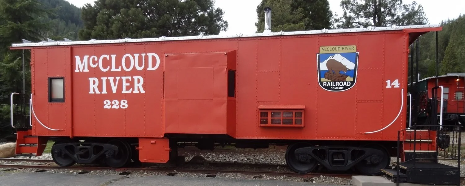 Red McCloud River caboose #14  with stairs showing on both ends.