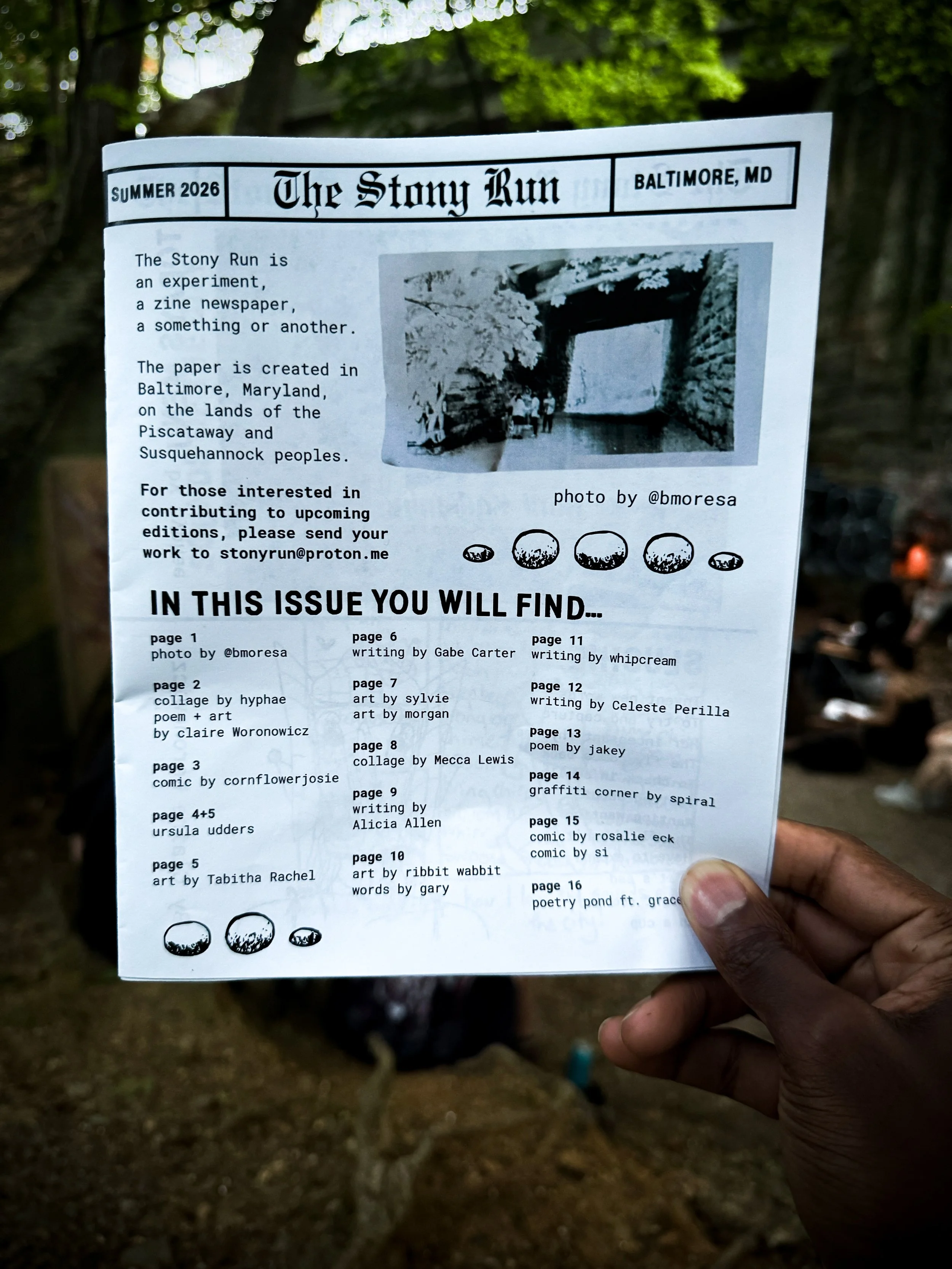 The stony Run Zine held up in front of the Stony Run Bridge