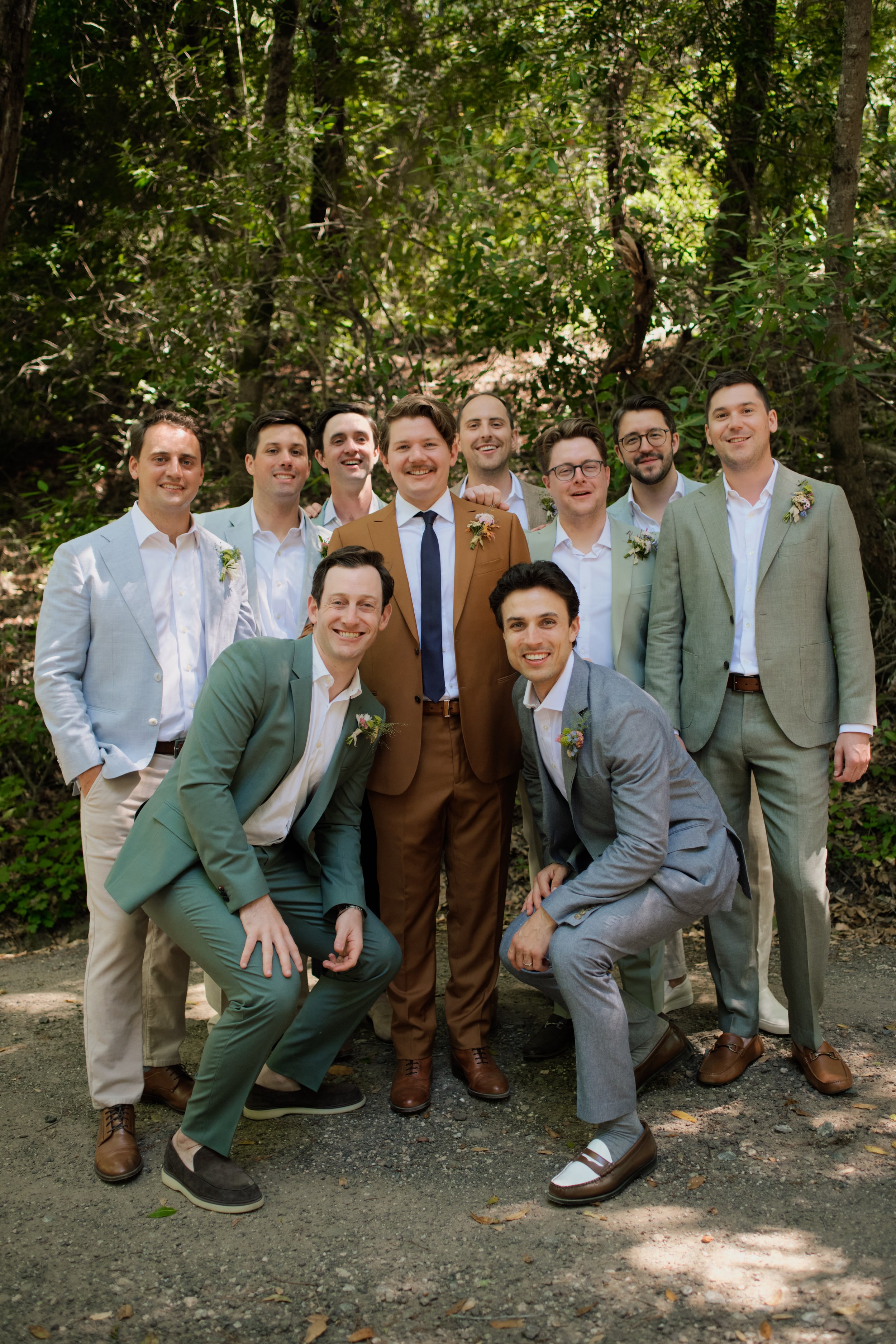 groomsmen in the forest together 