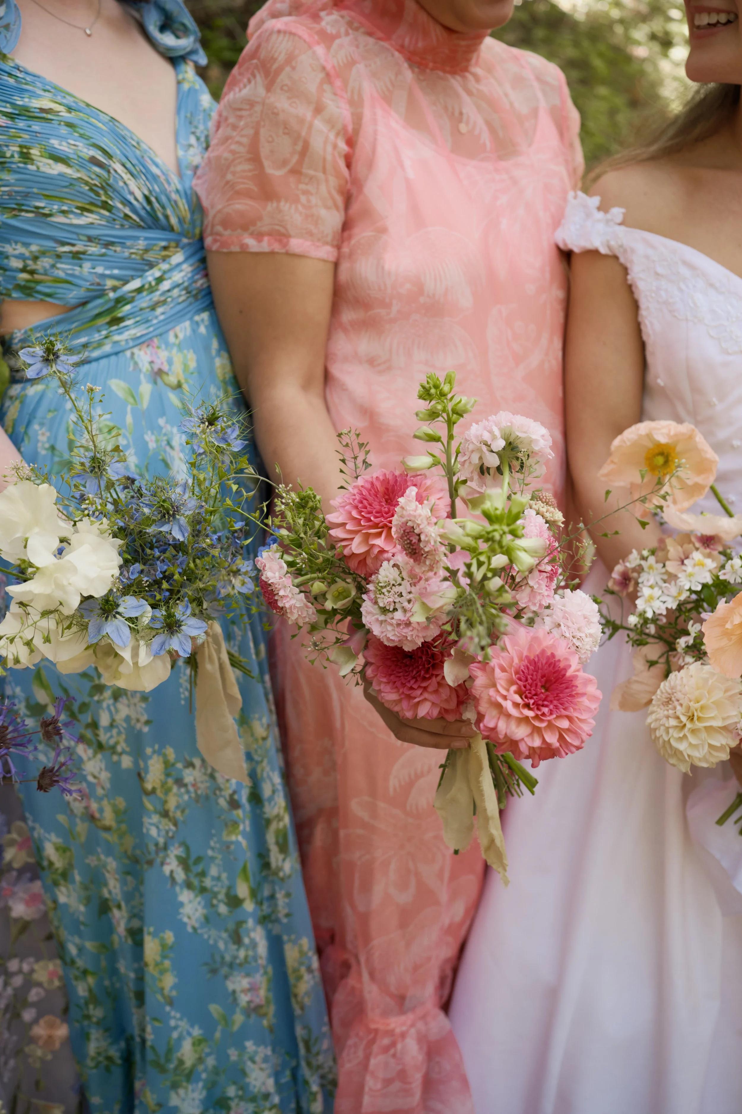 close up bridesmaids bouquets with local summer blooms