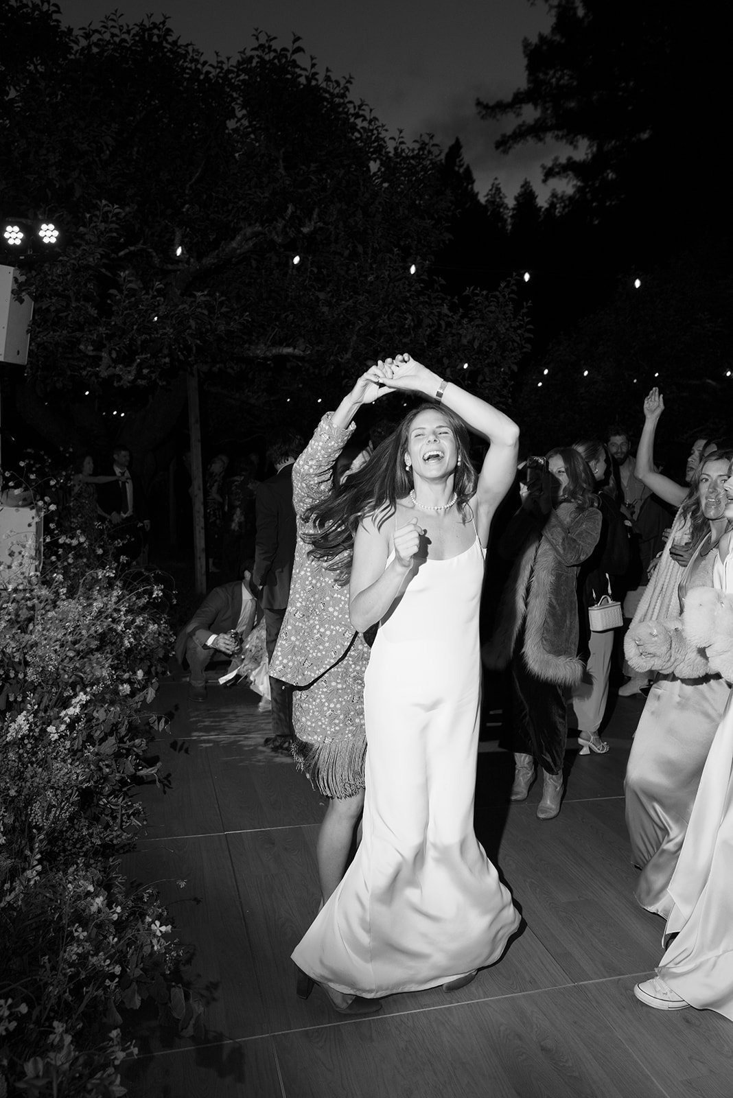 bride is dancing with joy at her wedding reception